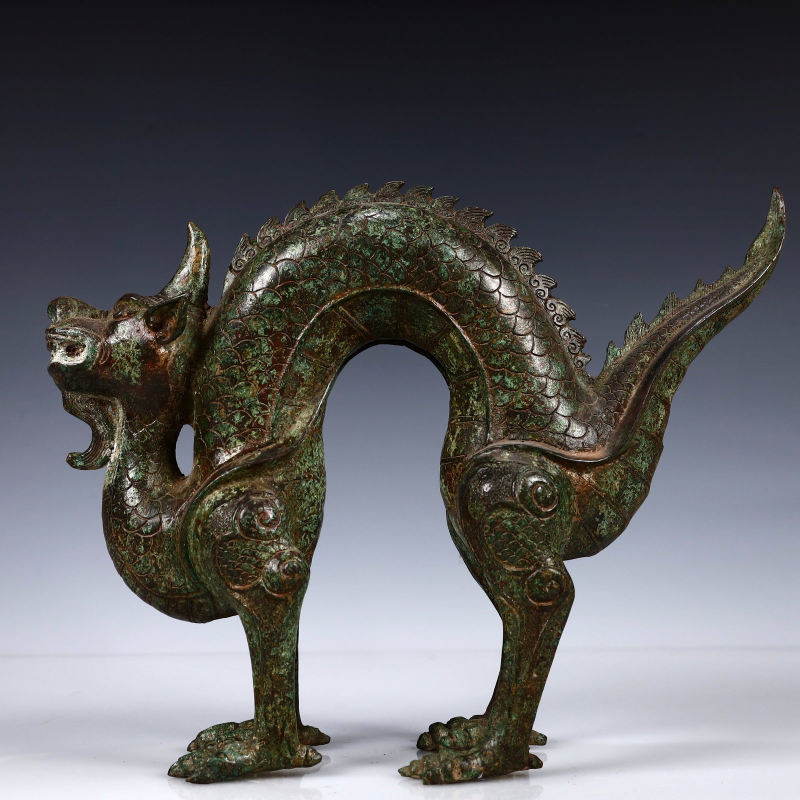 A Rare Bronze Dragon Ornament: A Rare Bronze Dragon Ornament,the Warring States period in China,Size:13inx9.8inx3.9in,Weight:3000g 青铜龙摆件,中国战国时期