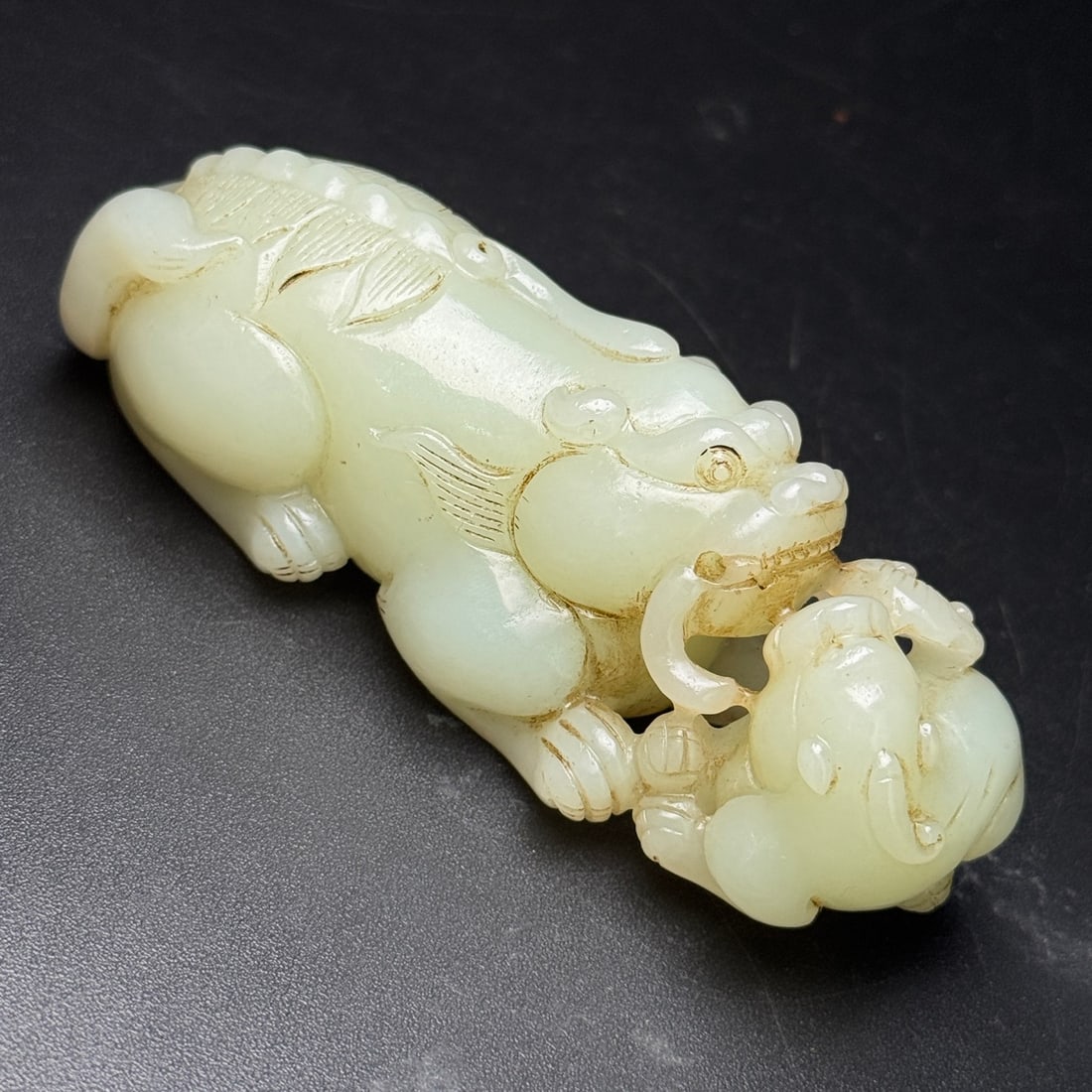An Exquisite White Jade Auspicious Beast Hand Piece: An Exquisite White Jade Auspicious Beast Hand Piece,Qing Dynasty,China,Size:107mmx38mmx38mm,Weight:205g 白玉瑞兽手把件,中国清代