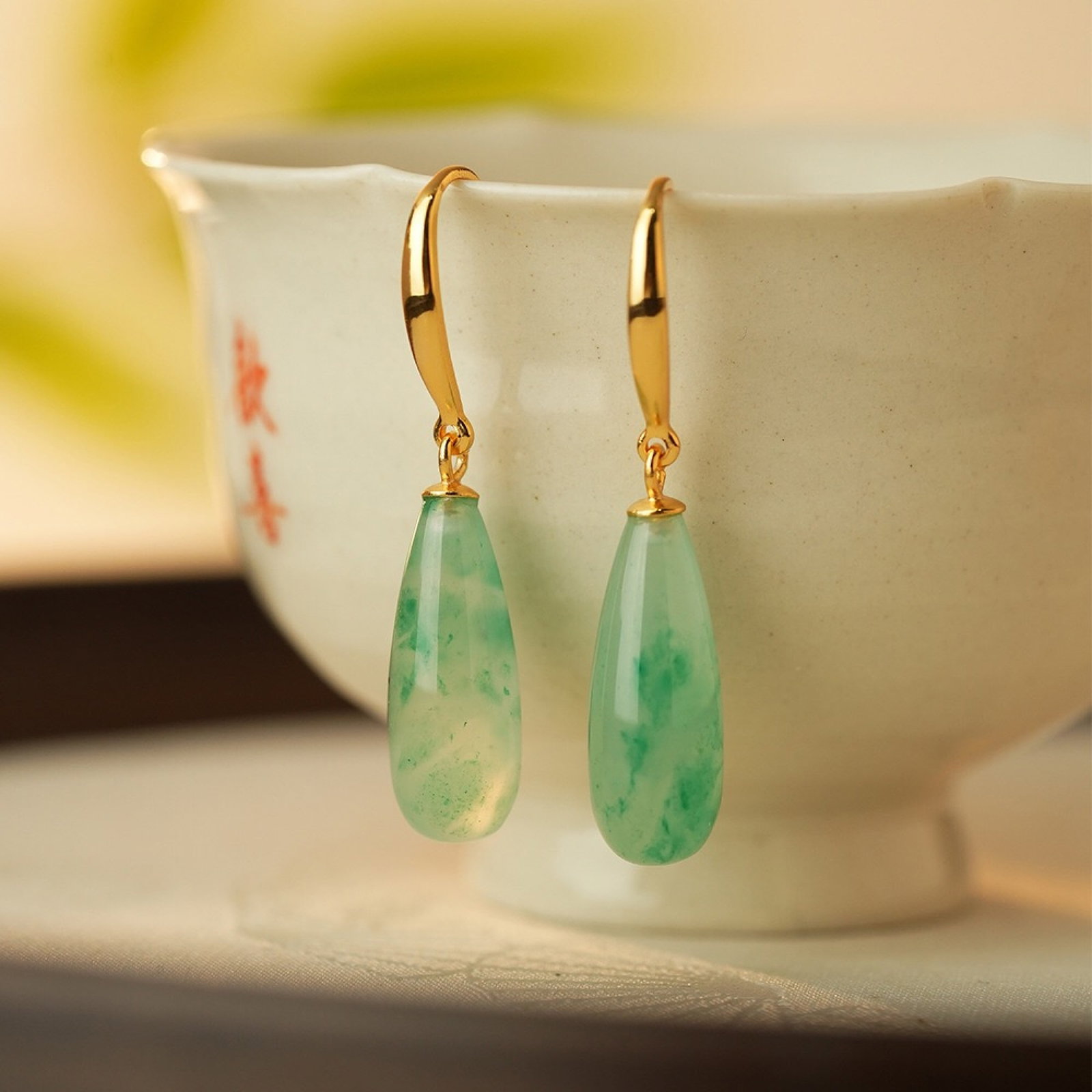 A Pair of Exquisite Sterling Silver-Gold Plated Inlaid Jadeite Earrings: A Pair of Exquisite Sterling Silver-Gold Plated Inlaid Jadeite Earrings,Size:7mmx35.2mm,Weight:3.24g 一对纯银镀金镶翡翠耳环
