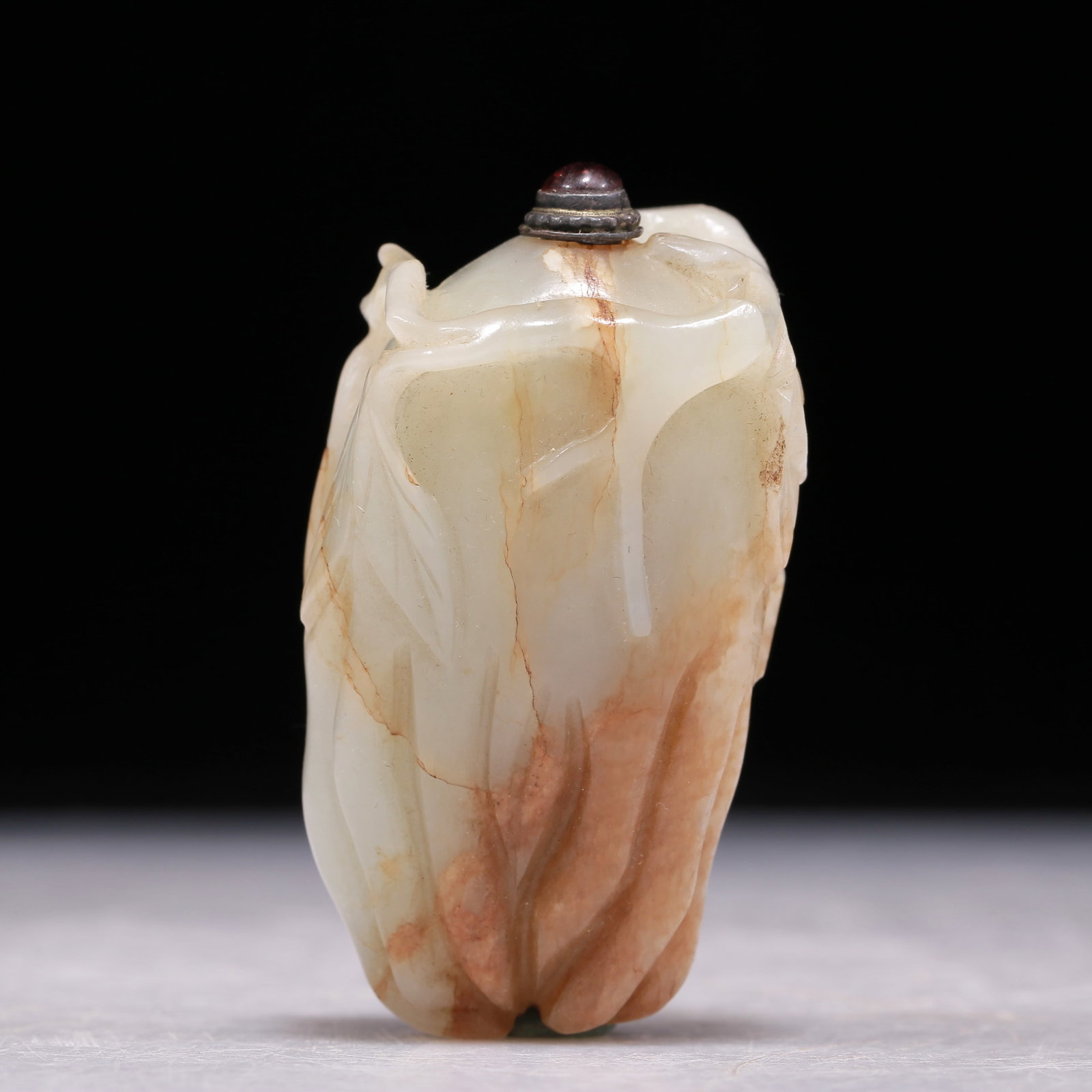 A Precious White Jade 'Finger Citron' Snuff Bottle: A Precious White Jade 'Finger Citron' Snuff Bottle. The fruit extended to elongated sinuous 'fingers' with furled ends, borne on gnarled, leafy stems, the stone of a white tone with russet inclusions.