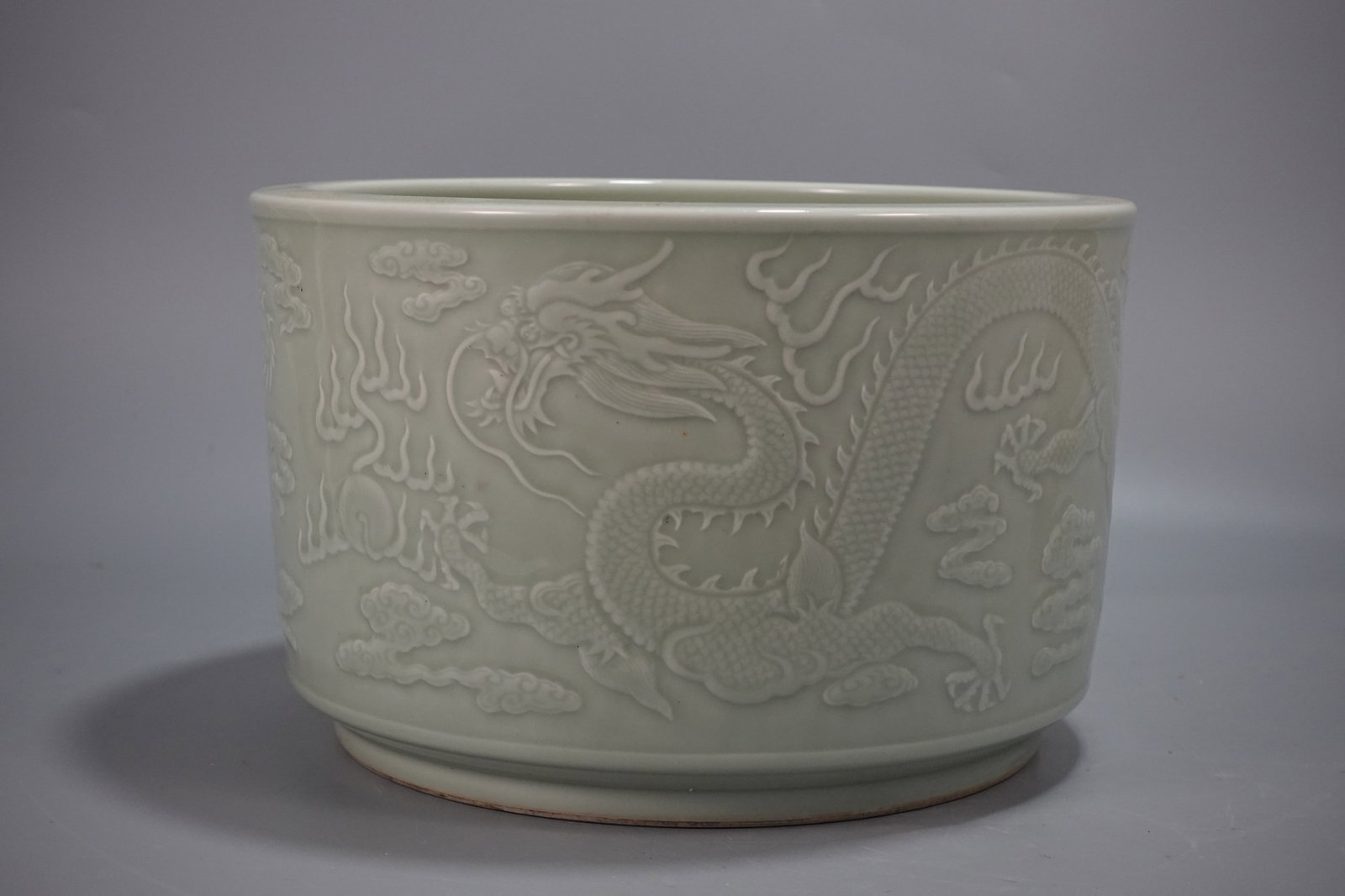 A Rare Celadon Glazed Auspicious Cloud and Dragon Pattern Water Pot: A Rare Celadon Glazed Auspicious Cloud and Dragon Pattern Water Pot,Qing Dynasty,China,Qianlong Six-character Mark,Size:7.6inx12in 青釉祥云龙纹水盂,