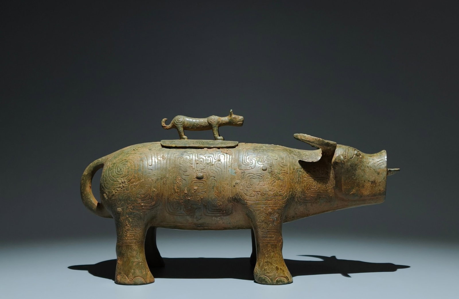 An Archaic Bronze Chi-Dragon Pattern Buffalo-Shaped Food Vessel,With Inscription: An Archaic Bronze Chi-Dragon Pattern Buffalo-Shaped Food Vessel,With Inscription,W.Zhou,China,Size:7.9inx14.2inx4.9in 青铜螭龙纹牛形食器,带&