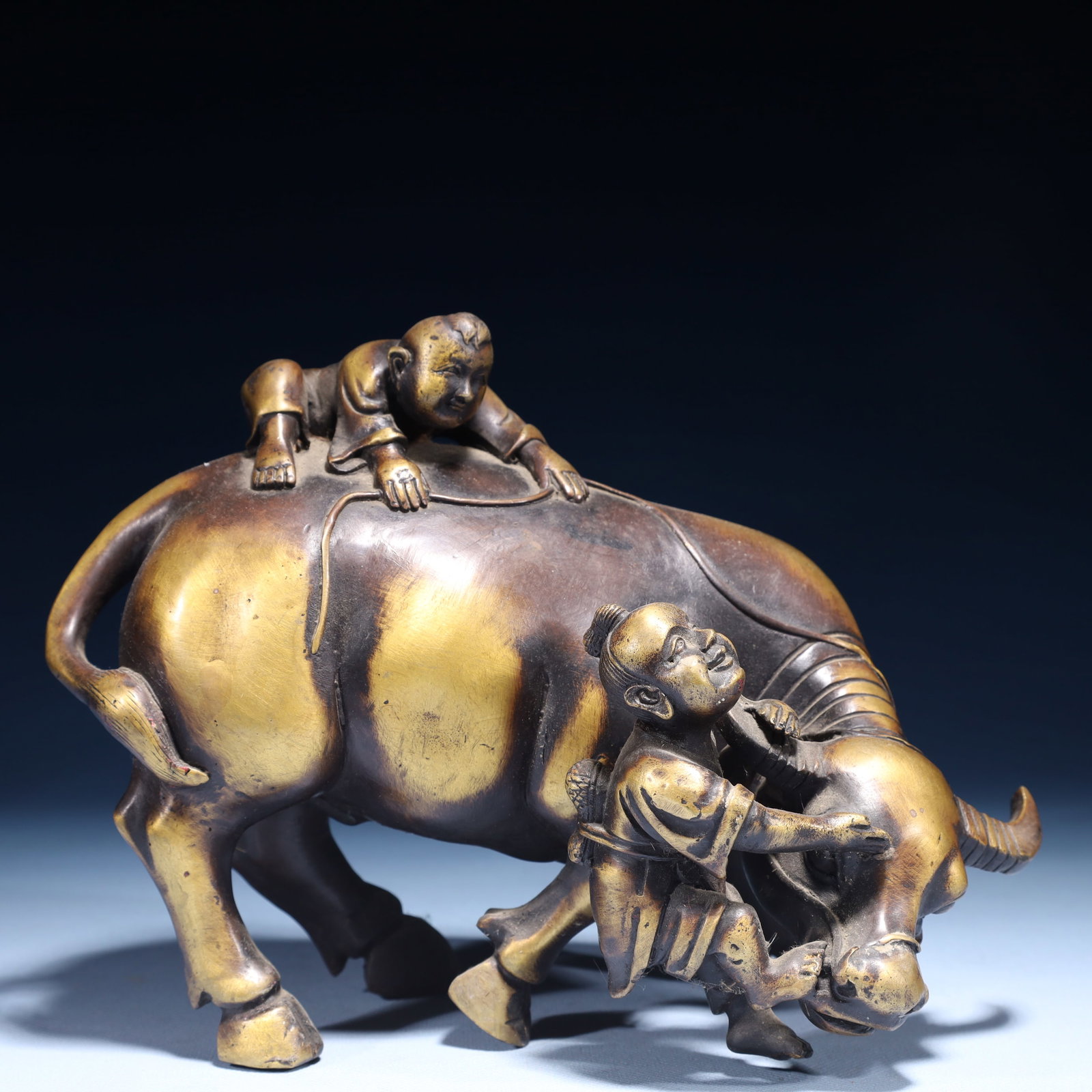 An Exquisite Bronze Figure Riding Buffalo Ornament: An Exquisite Bronze Figure Riding Buffalo Ornament,Qing Dynasty,China,Size:9.1inx4.7inx7.1in,Weight:3250g 铜人物骑牛摆件,中国清代