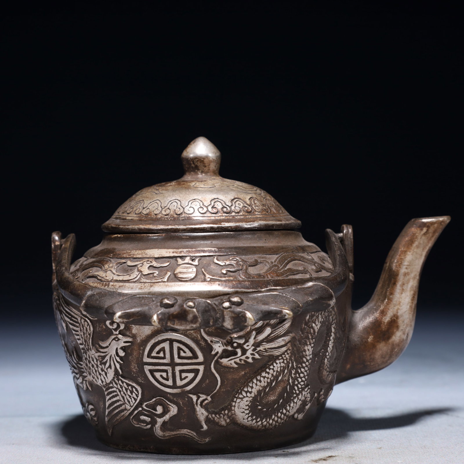 An Exquisite Silver-plated Bronze Dragon and Phoenix Pattern Loop-Handled Pot: An Exquisite Silver-plated Bronze Dragon and Phoenix Pattern Loop-Handled Pot,Qing Dynasty,China,Qianlong Four-character Mark,Size:5.9inx3.9inx5.5in,Weight:600g 铜镀银龙凤
