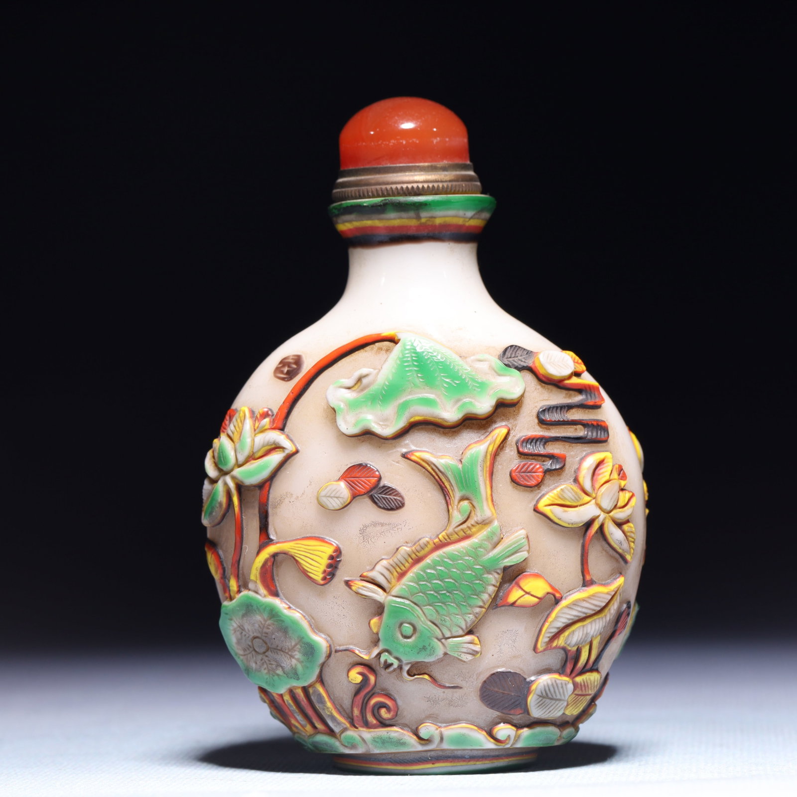 An Exquisite Glass Lotus Fish Pattern Snuff Bottle: An Exquisite Glass Lotus Fish Pattern Snuff Bottle,Qing Dynasty,China,Size:2.8inx1.6inx3.9in,Weight:167.9g 琉璃莲花鱼纹鼻烟壶,中国