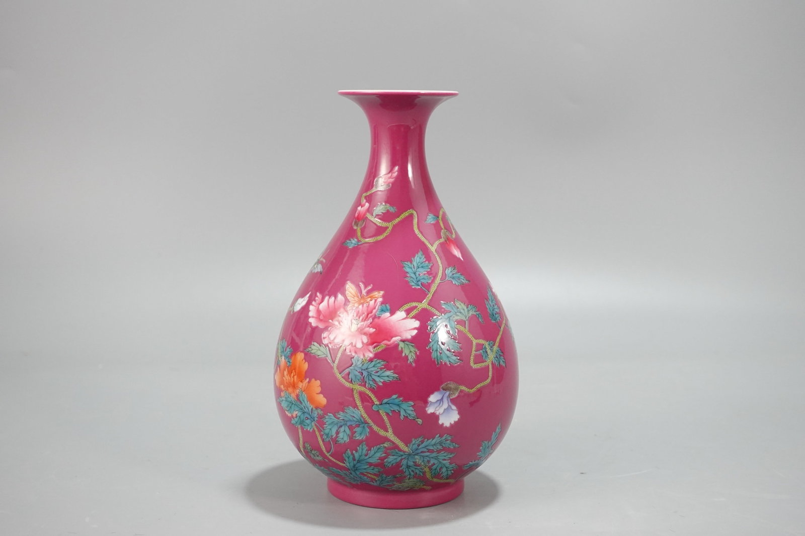An Exquisite Ruby Red-Ground Enamel Flower and Butterfly Pattern Vase,with poem: An Exquisite Ruby Red-Ground Enamel Flower and Butterfly Pattern Vase,with poem,Qing Dynasty,China,Yongzheng Six-character Mark,Size:7.9inx4.7in 胭脂红地珐琅彩