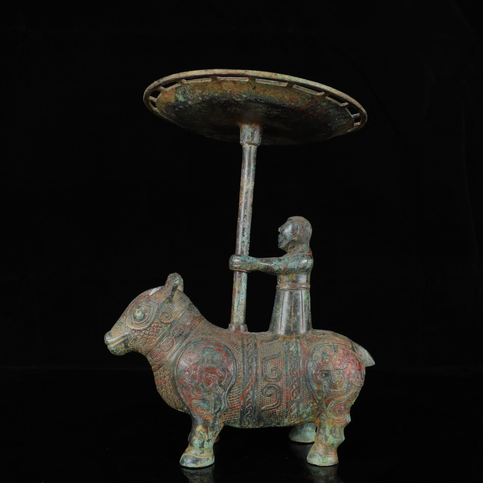 An Archaic Bronze Dragon Pattern Figure Riding Auspicious Beast Ornament: An Archaic Bronze Dragon Pattern Figure Riding Auspicious Beast Ornament,the Warring States Period in China,Size:9.8inx8.7inx13in,Weight:2900g 青铜龙纹人物骑&