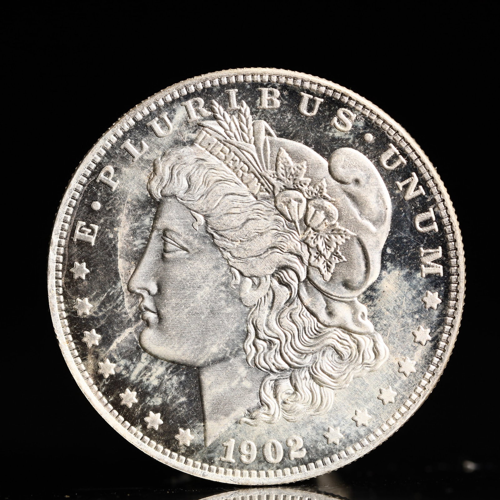USA Morgan Dollar 1902 Coin: Obv: profile bust with date below and E PLURIBUS UNUM legend and stars around. Rev: eagle with In God we trust above within wreath with UNITED STATES OF AMERICA ONE DOLLAR legend. IN GOD WE TRUST / LI