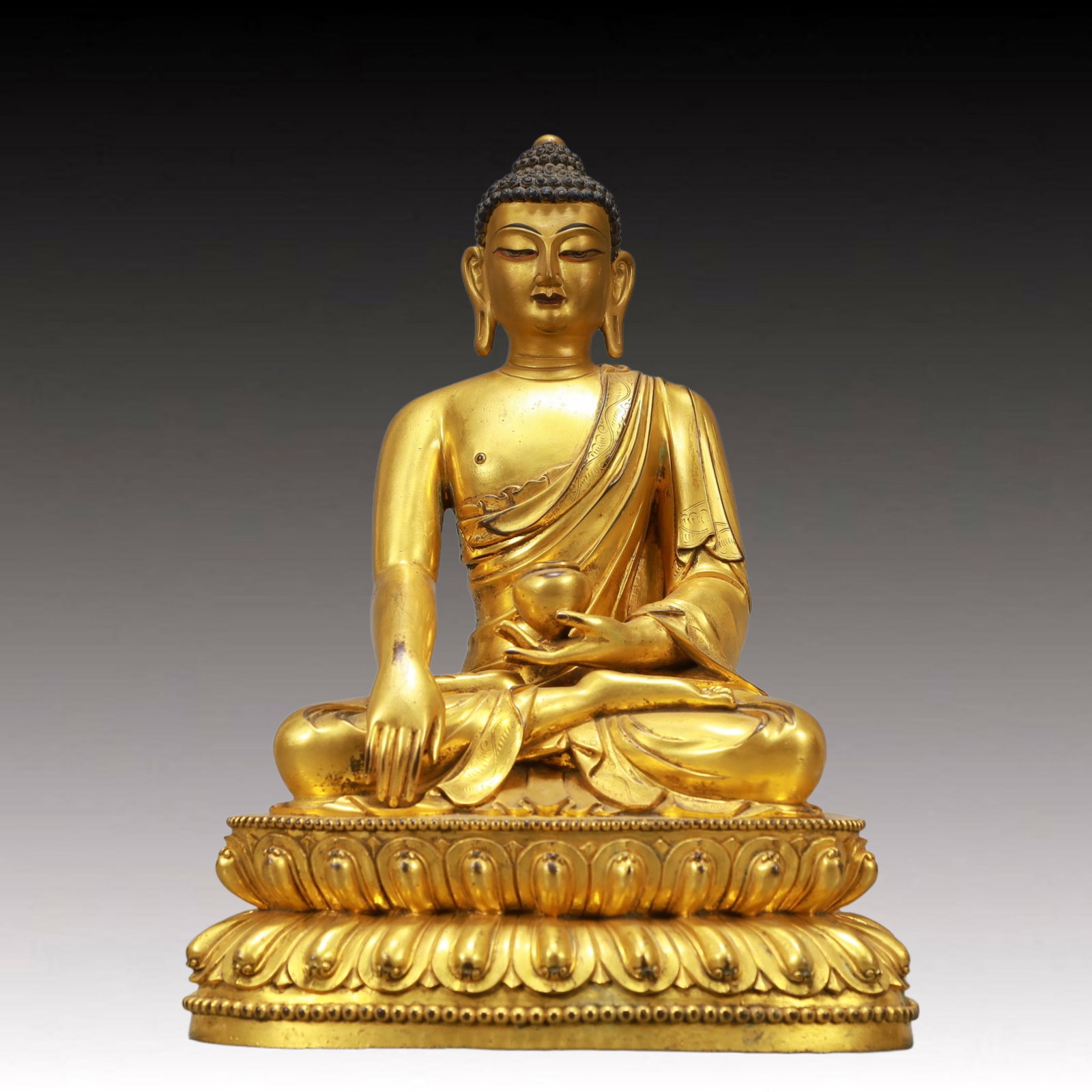 A Solemn Gilt Bronze Statue of Sakyamuni: A Solemn Gilt Bronze Statue of Sakyamuni,Ming Dynasty, China,Size:9.4inx6.3inx13in,Weight:6800g 铜鎏金释迦摩尼像,中国明代