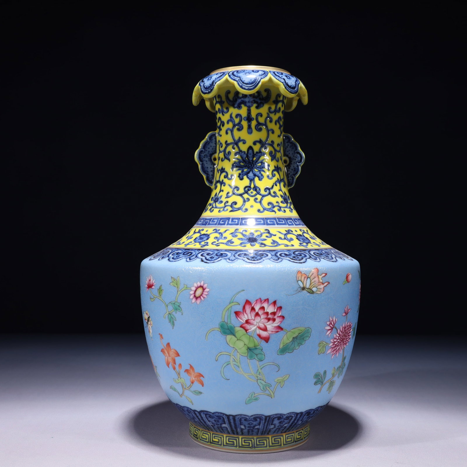 An Exquisite Blue Ground Famille-Rose Painted Gold Flower and Butterfly Pattern Double-Ears Vase: An Exquisite Blue Ground Famille-Rose Painted Gold Flower and Butterfly Pattern Double-Ears Vase,Qing Dynasty,China,Qianlong Six-character Mark,Size:6.7inx12.2in,Weight:2050g 蓝地粉&
