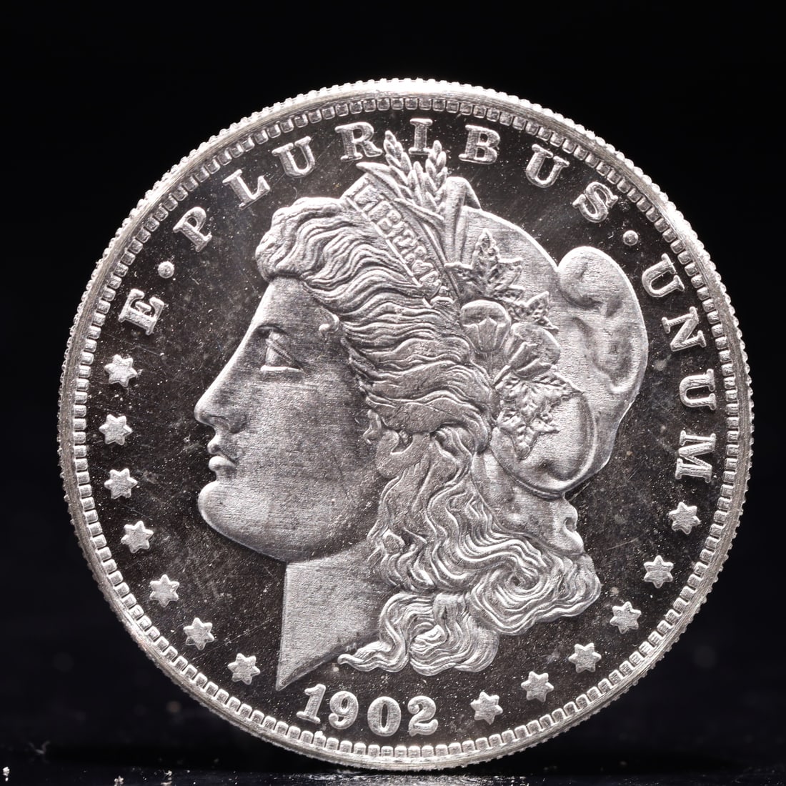 USA Morgan Dollar 1902 Coin: Obv: profile bust with date below and E PLURIBUS UNUM legend and stars around. Rev: eagle with In God we trust above within wreath with UNITED STATES OF AMERICA ONE DOLLAR legend. IN GOD WE TRUST / LI