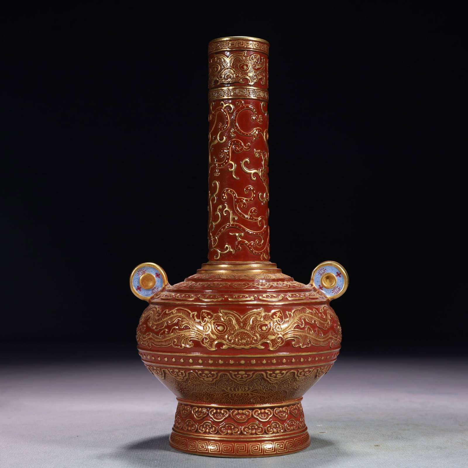 An Exquisite Red Glazed Painted Gold Beast-Face Pattern Double-Ears Vase: An Exquisite Red Glazed Painted Gold Beast-Face Pattern Double-Ears Vase,Qing Dynasty,China,Qianlong Six-character Mark,Size:4.3inx7.9in,Weight:400g 红釉描金兽面