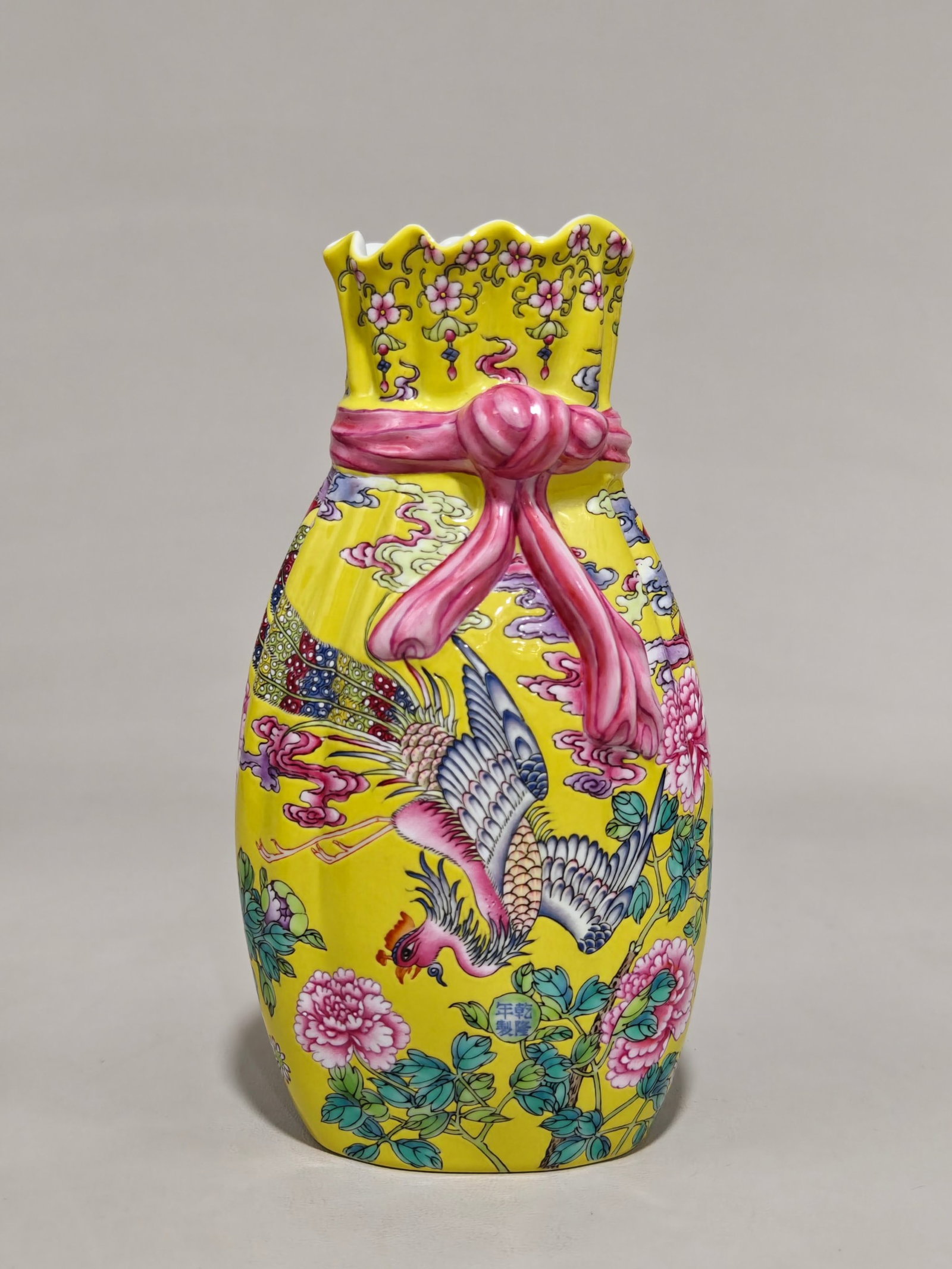 An Exquisite Yellow Ground Famille-Rose Flower and Phoenix Pattern Vase: An Exquisite Yellow Ground Famille-Rose Flower and Phoenix Pattern Vase,Qing Dynasty,China,Qianlong Four-character Mark,Size:7.3inx3.9in 黄地粉彩花卉凤纹