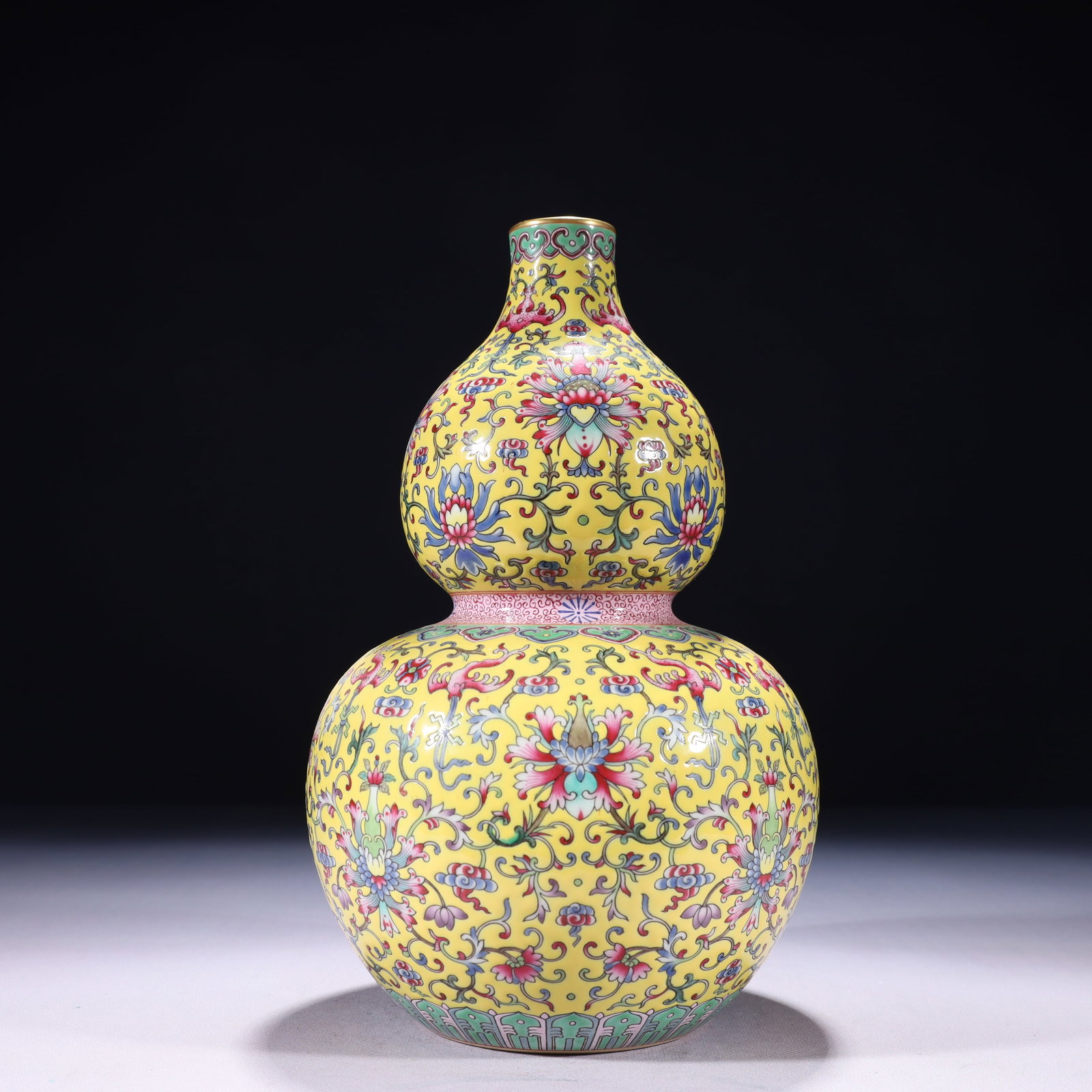 An Exquisite Yellow Ground Famille-Rose Painted Gold Lotus Pattern Gourd-Shaped Vase: An Exquisite Yellow Ground Famille-Rose Painted Gold Lotus Pattern Gourd-Shaped Vase,Qing Dynasty,China,Qianlong Six-character Mark,Size:5.9inx11in,Weight:1550g