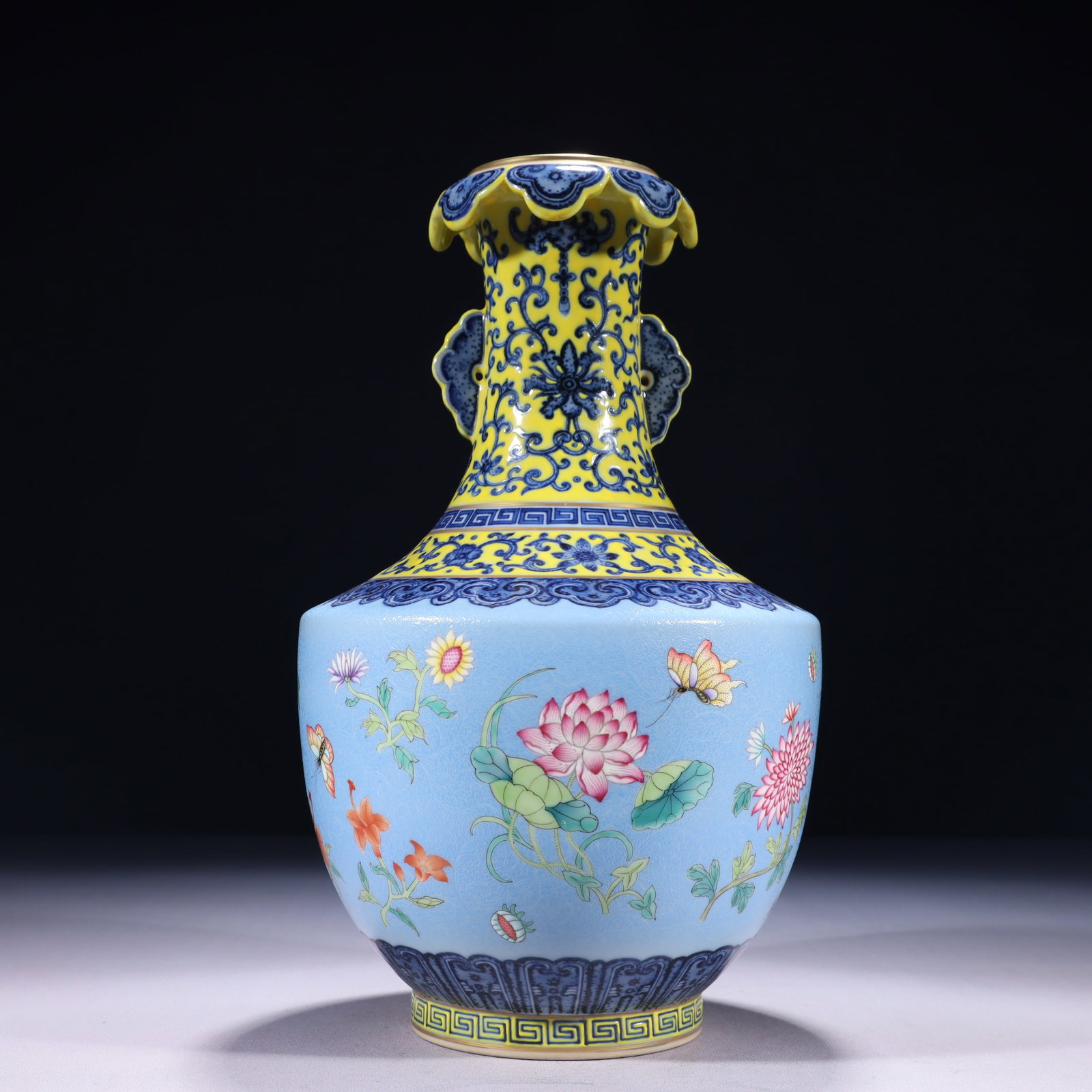 An Exquisite Blue Ground Famille-Rose Painted Gold Flower and Butterfly Pattern Double-Ears Vase: An Exquisite Blue Ground Famille-Rose Painted Gold Flower and Butterfly Pattern Double-Ears Vase,Qing Dynasty,China,Qianlong Six-character Mark,Size:6.7inx12.2in,Weight:2000g 蓝地粉&
