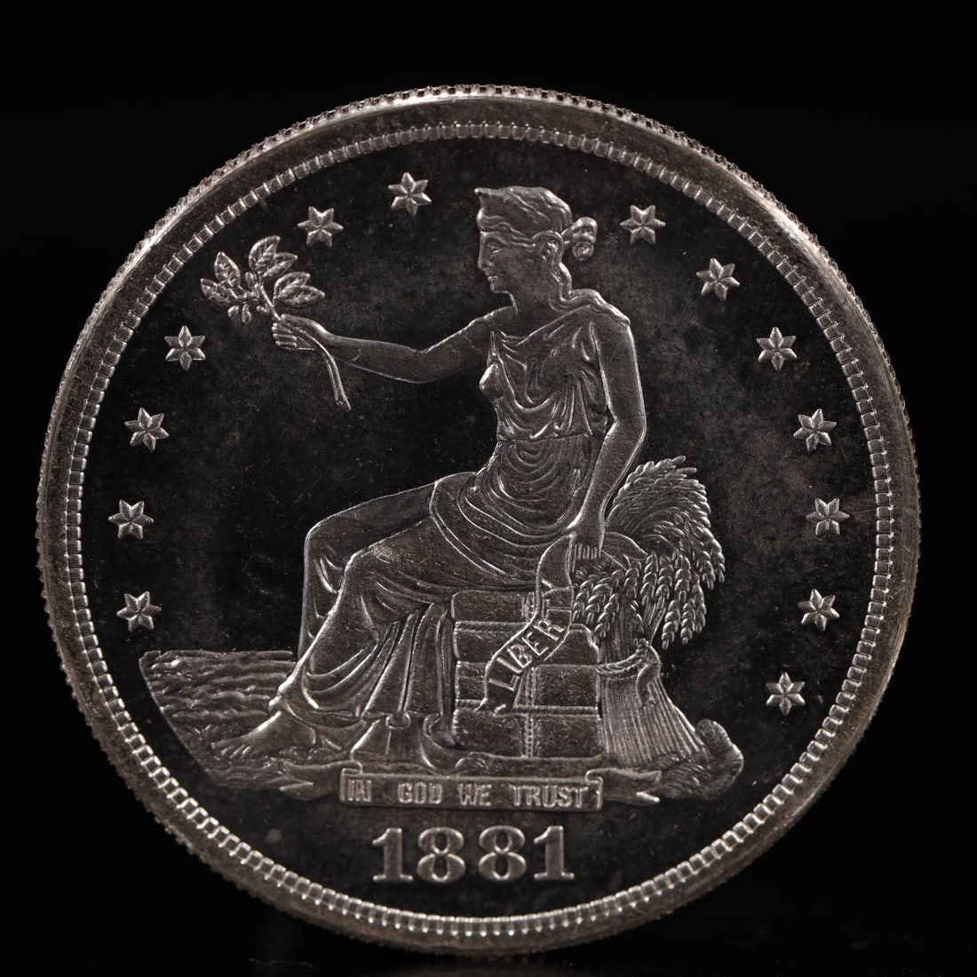 USA Trade Dollar 1881 Coin: American coin. Obverse: Liberty seated on a pedestal facing the sea to the left holding olive branches surrounded by 13 stars. IN GOD WE TRUST / LIBERTY / 1881. Reverse: An eagle holding branches with