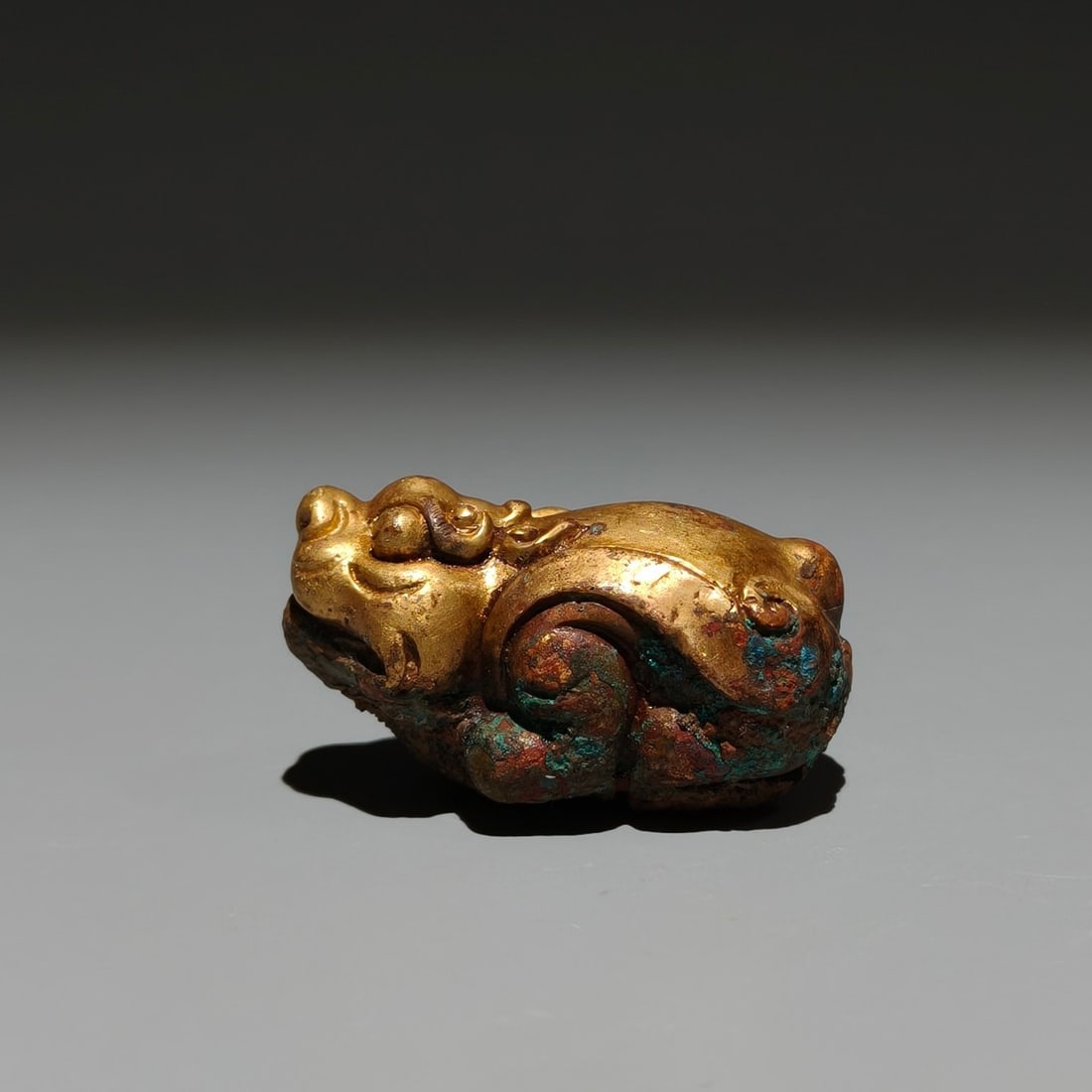 An Exquisite Gilt Bronze Wealth-Attracting Creature Ornament: An Exquisite Gilt Bronze Wealth-Attracting Creature Ornament,Han Dynasty,China,Size:1inx1.8inx1in 铜鎏金貔貅摆件,中国汉代