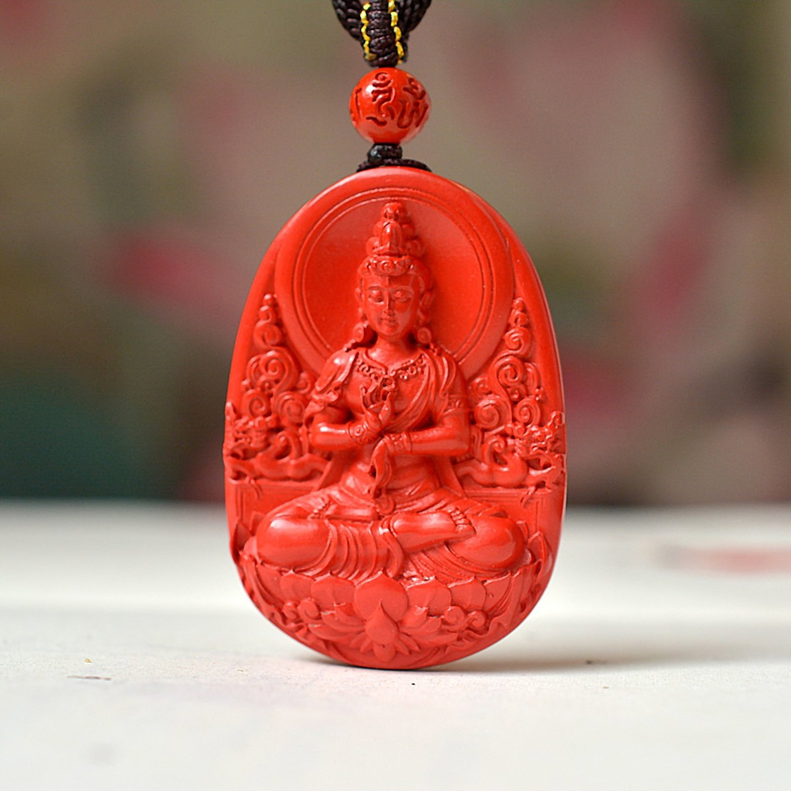An Exquisite Cinnabar Pendant with Statue of Avalokitesvara (1 of 5)