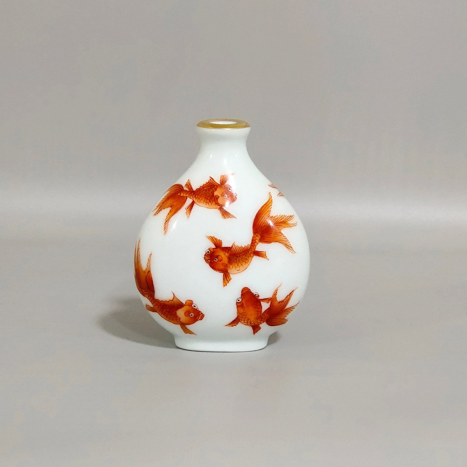 An Exquisite Iron-Red Painted Gold Goldfish Pattern Snuff Bottle: An Exquisite Iron-Red Painted Gold Goldfish Pattern Snuff Bottle,Qing Dynasty,China,Qianlong Four-character Mark,Size:2.5inx2in 矾红釉描金金鱼纹鼻