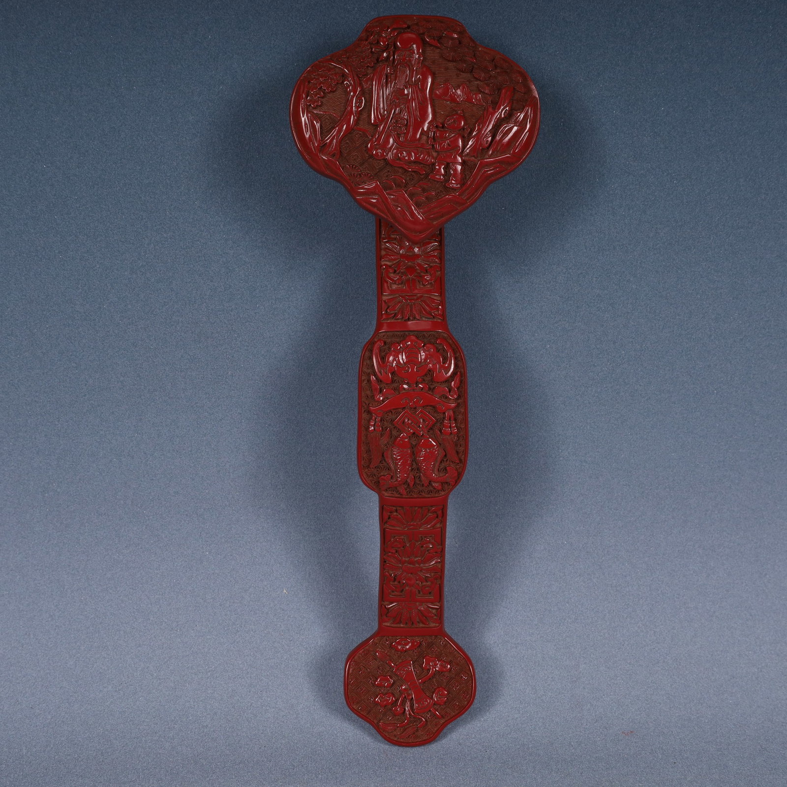 A Rare Carved Red Lacquer Lotus and Figure Pattern Ruyi: A Rare Carved Red Lacquer Lotus and Figure Pattern Ruyi,Qing Dynasty, China,Size:13.4inx4.5inx2.6in,Weight:350g 剔红漆缠枝莲人物纹如意