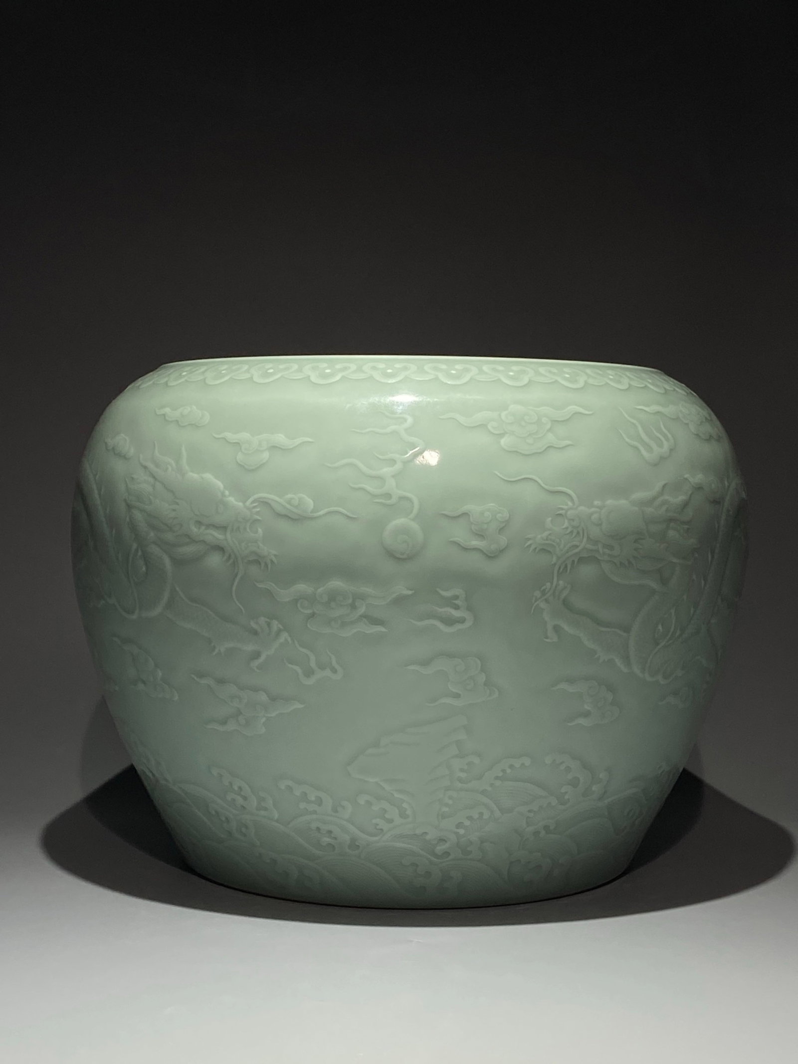 A Rare Celadon Glazed Seawater,Auspicious Cloud and Dragon Pattern Vat: A Rare Celadon Glazed Seawater,Auspicious Cloud and Dragon Pattern Vat,Qing Dynasty,China,Qianlong Six-character Mark,Size:10.6inx15in 粉青釉海水祥云龙&