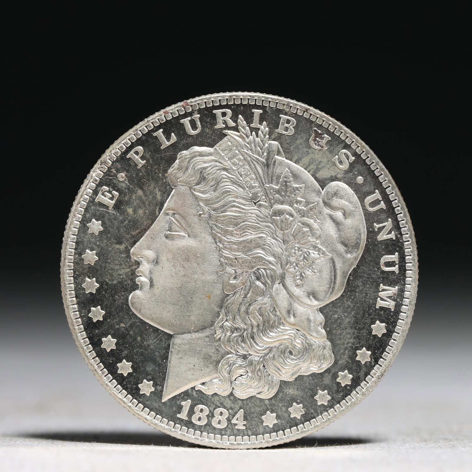 USA Morgan Dollar 1884 Coin: Obv: profile bust with date below and E PLURIBUS UNUM legend and stars around. Rev: eagle with In God we trust above within wreath with UNITED STATES OF AMERICA ONE DOLLAR legend. IN GOD WE TRUST / LI