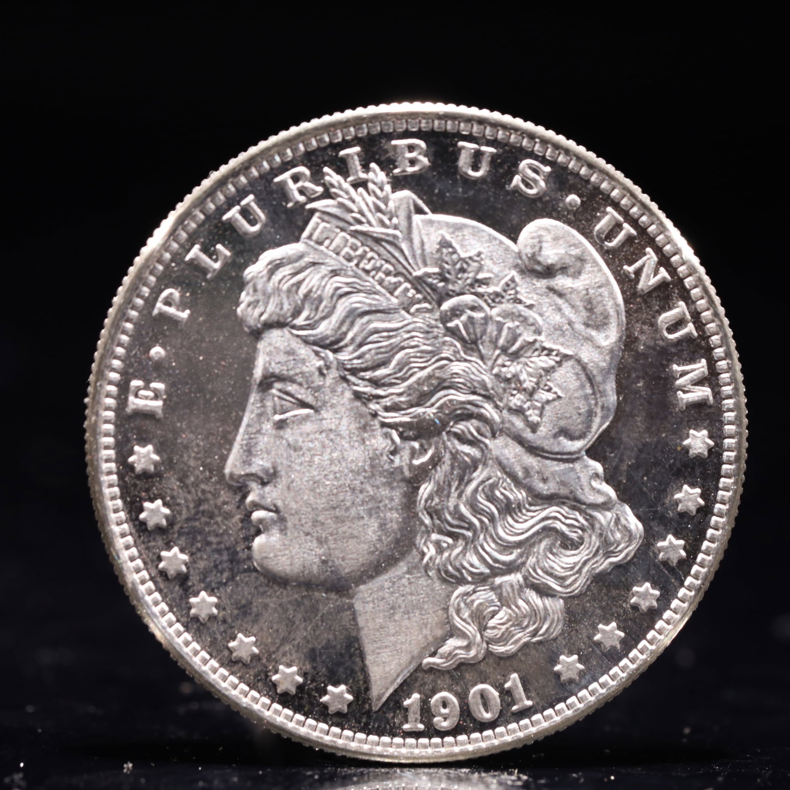 USA Morgan Dollar 1901 Coin: Obv: profile bust with date below and E PLURIBUS UNUM legend and stars around. Rev: eagle with In God we trust above within wreath with UNITED STATES OF AMERICA ONE DOLLAR legend. IN GOD WE TRUST / LI