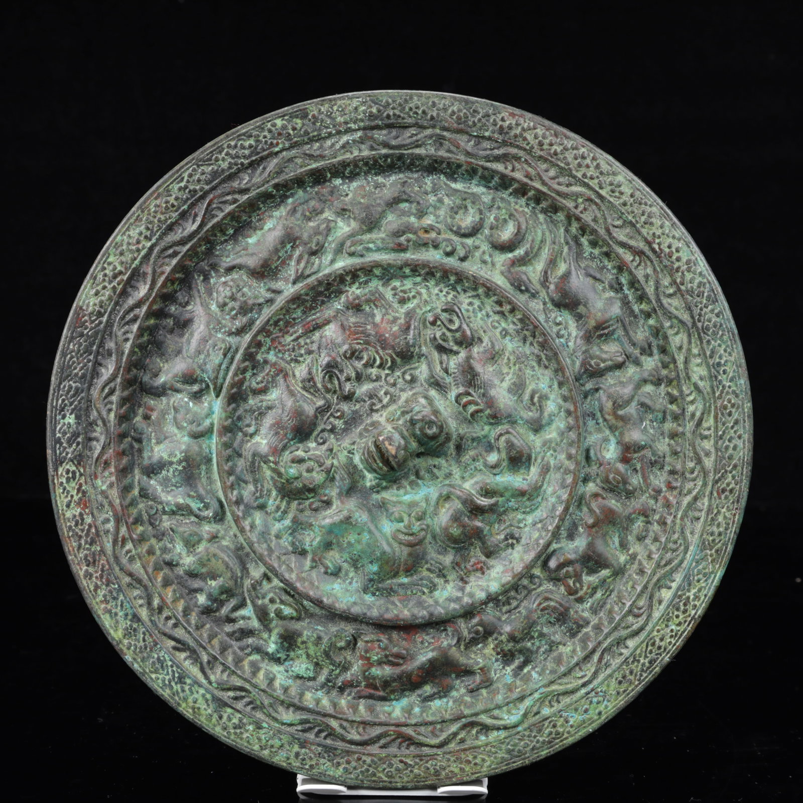An Archaic Bronze Animal Pattern Round Mirror: An Archaic Bronze Animal Pattern Round Mirror,The Warring States period in China,Size:8.3inx0.8in,Weight:2050g 青铜动物纹圆镜,中国战国