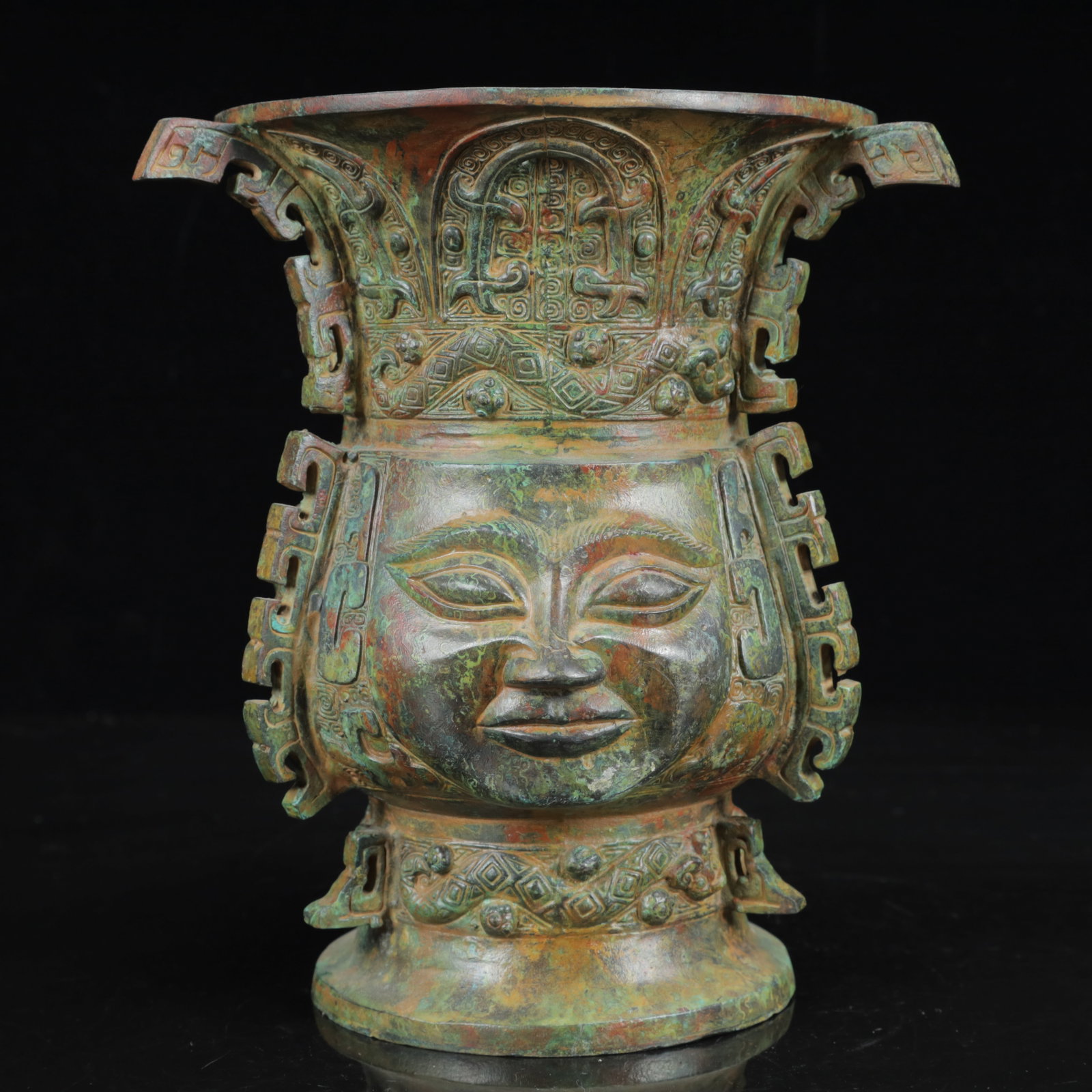 An Archaic Bronze Figure-Face Pattern Four Ears Vase: An Archaic Bronze Figure-Face Pattern Four Ears Vase,the Warring States Period in China,Size:7.1inx8.3in,Weight:1950g 青铜人面纹四耳瓶,中国&
