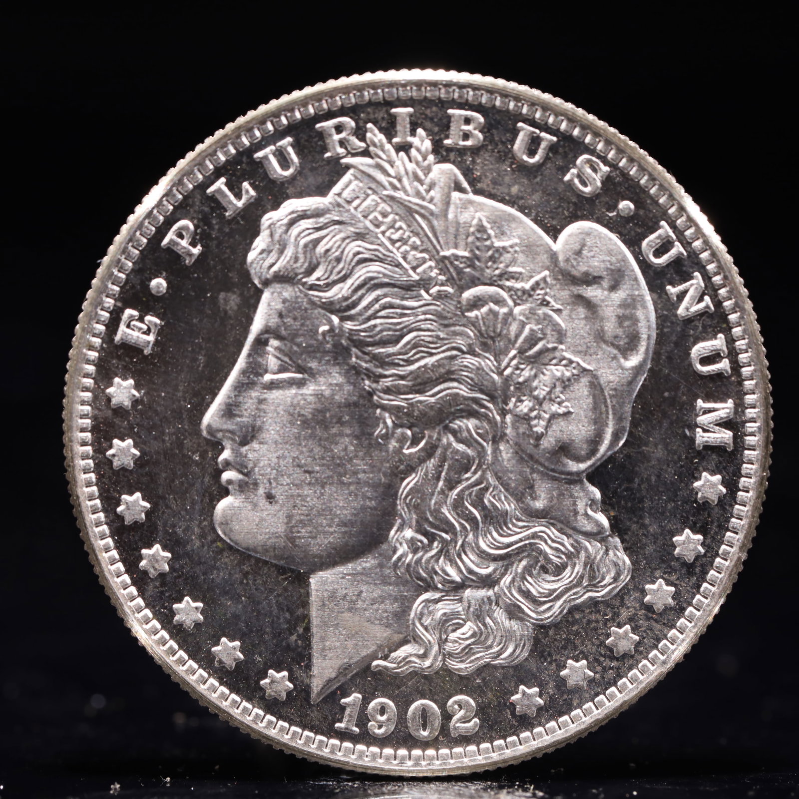 USA Morgan Dollar 1902 Coin: Obv: profile bust with date below and E PLURIBUS UNUM legend and stars around. Rev: eagle with In God we trust above within wreath with UNITED STATES OF AMERICA ONE DOLLAR legend. IN GOD WE TRUST / LI
