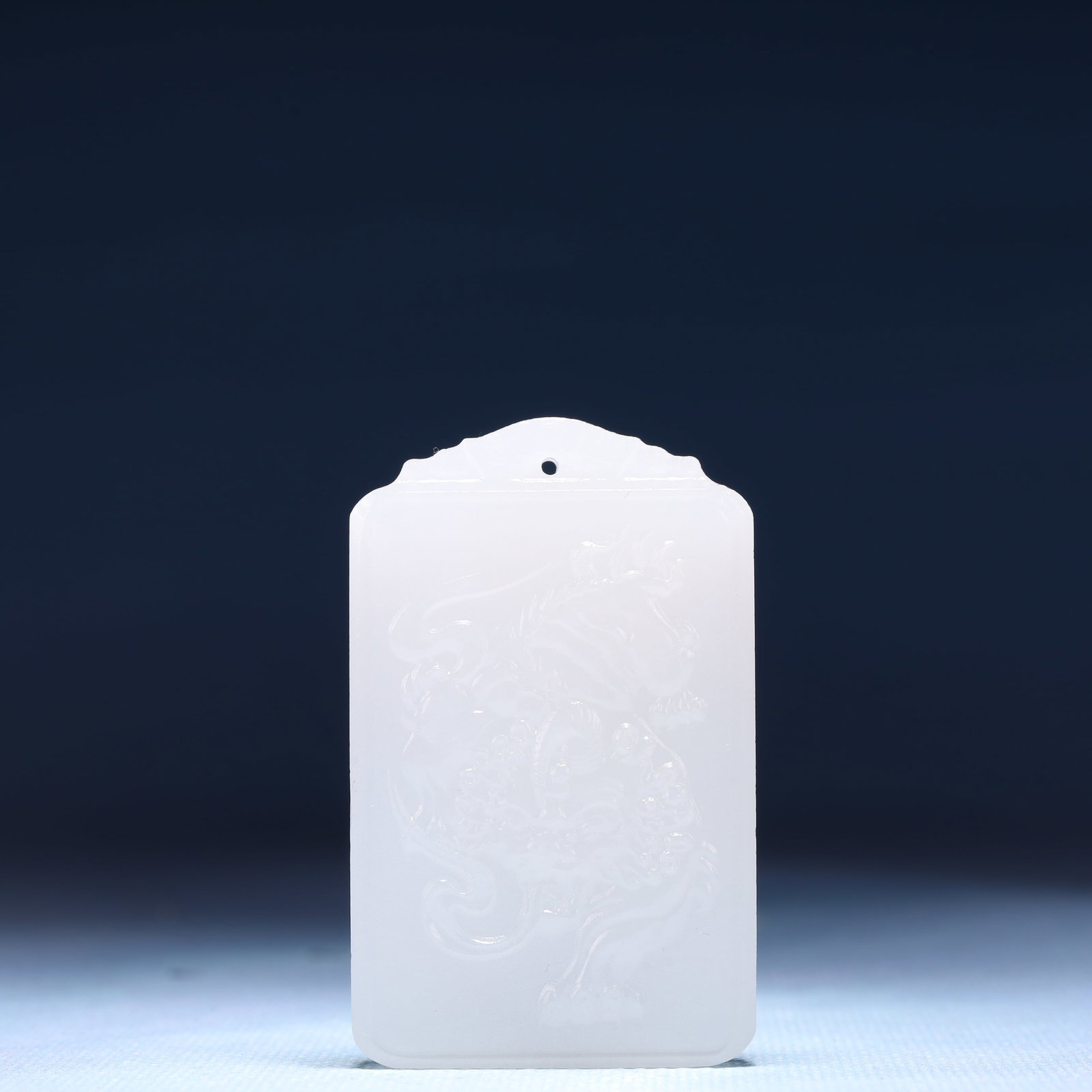 An Exquisite White Jade Lion Pattern Pendant: An Exquisite White Jade Lion Pattern Pendant,Size:1.6inx0.4inx2.4in,Weight:51g 白玉狮子纹牌