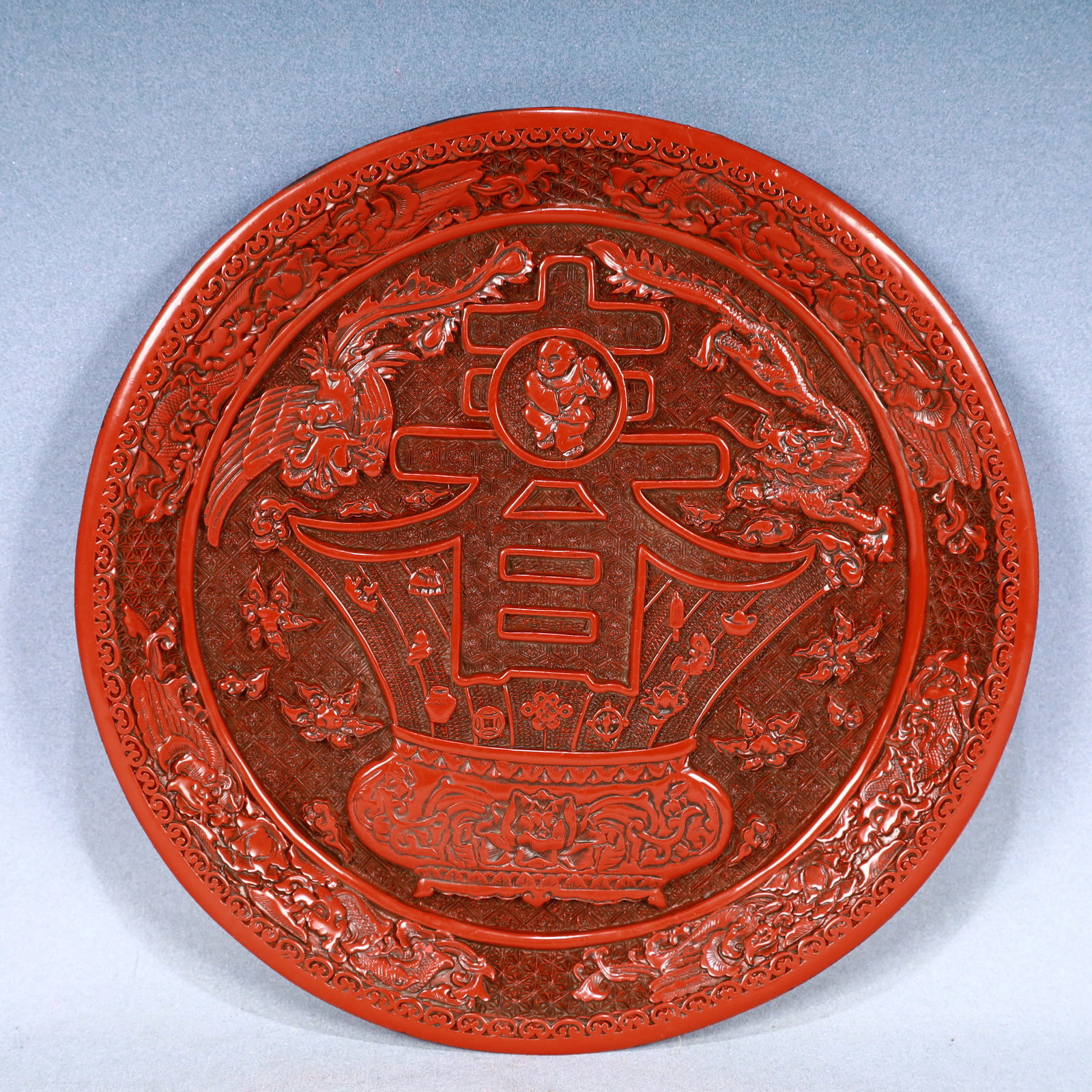 An Exquisite Carved Red Lacquer Dragon Pattern Plate: An Exquisite Carved Red Lacquer Dragon Pattern Plate,Qing Dynasty, China,Qianlong Six-character Mark,Size:11.6inx1.2in,Weight:1150g 剔红漆龙纹盘,中国