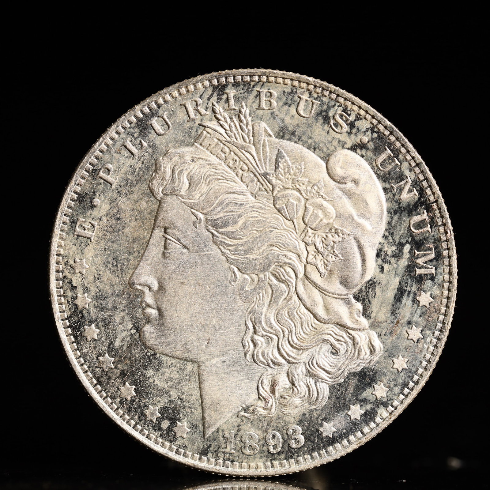 USA Morgan Dollar 1893 Coin: Obv: profile bust with date below and E PLURIBUS UNUM legend and stars around. Rev: eagle with In God we trust above within wreath with UNITED STATES OF AMERICA ONE DOLLAR legend. IN GOD WE TRUST / LI