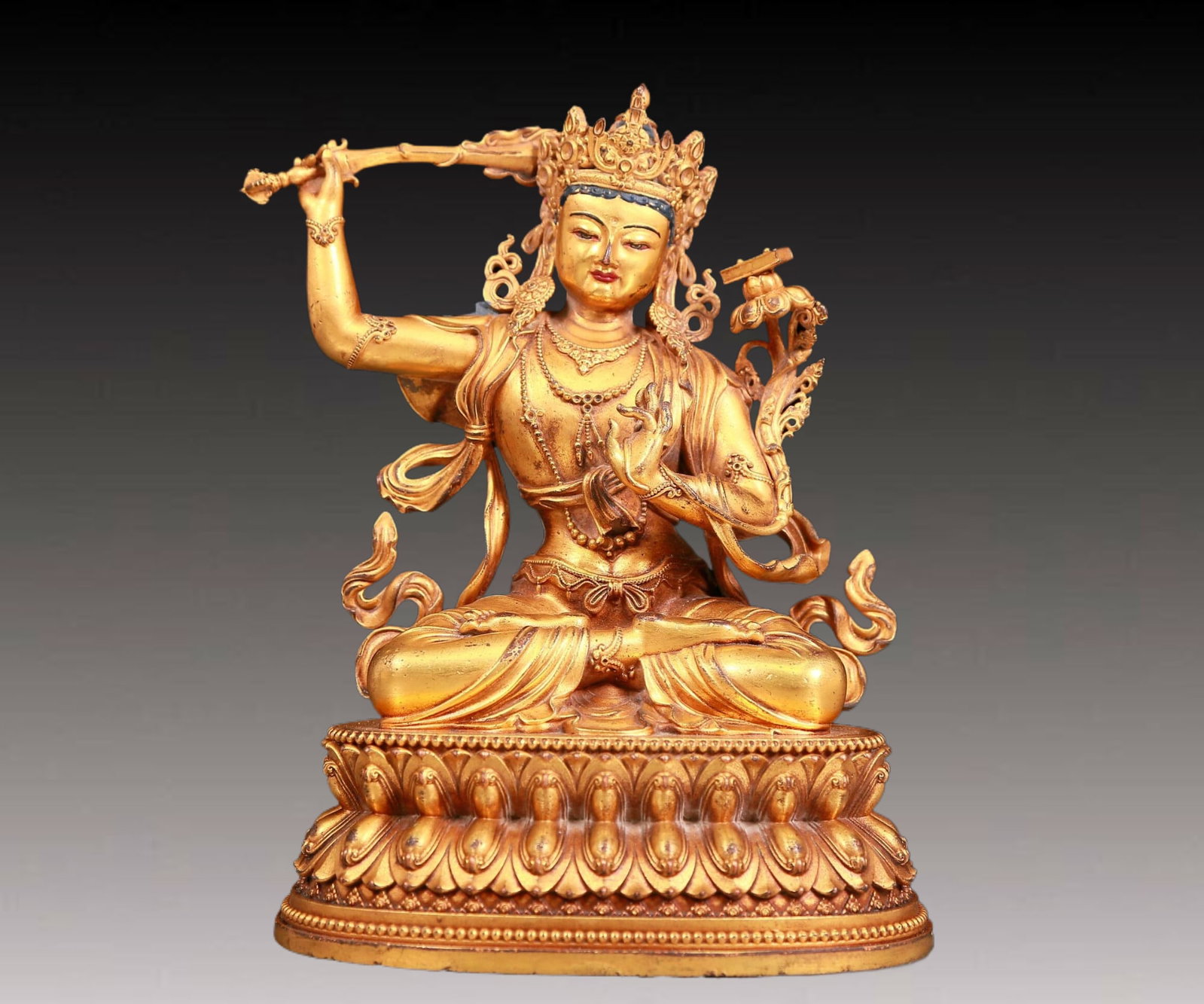 A solemn gilt bronze statue of Manjushri Bodhisattva: A solemn gilt bronze statue of Manjushri Bodhisattva,Yongle six-character mark,Ming Dynasty,China. Manjushri Bodhisattva wears a gorgeous crown adorned with gems,making it look more mysterious and A s