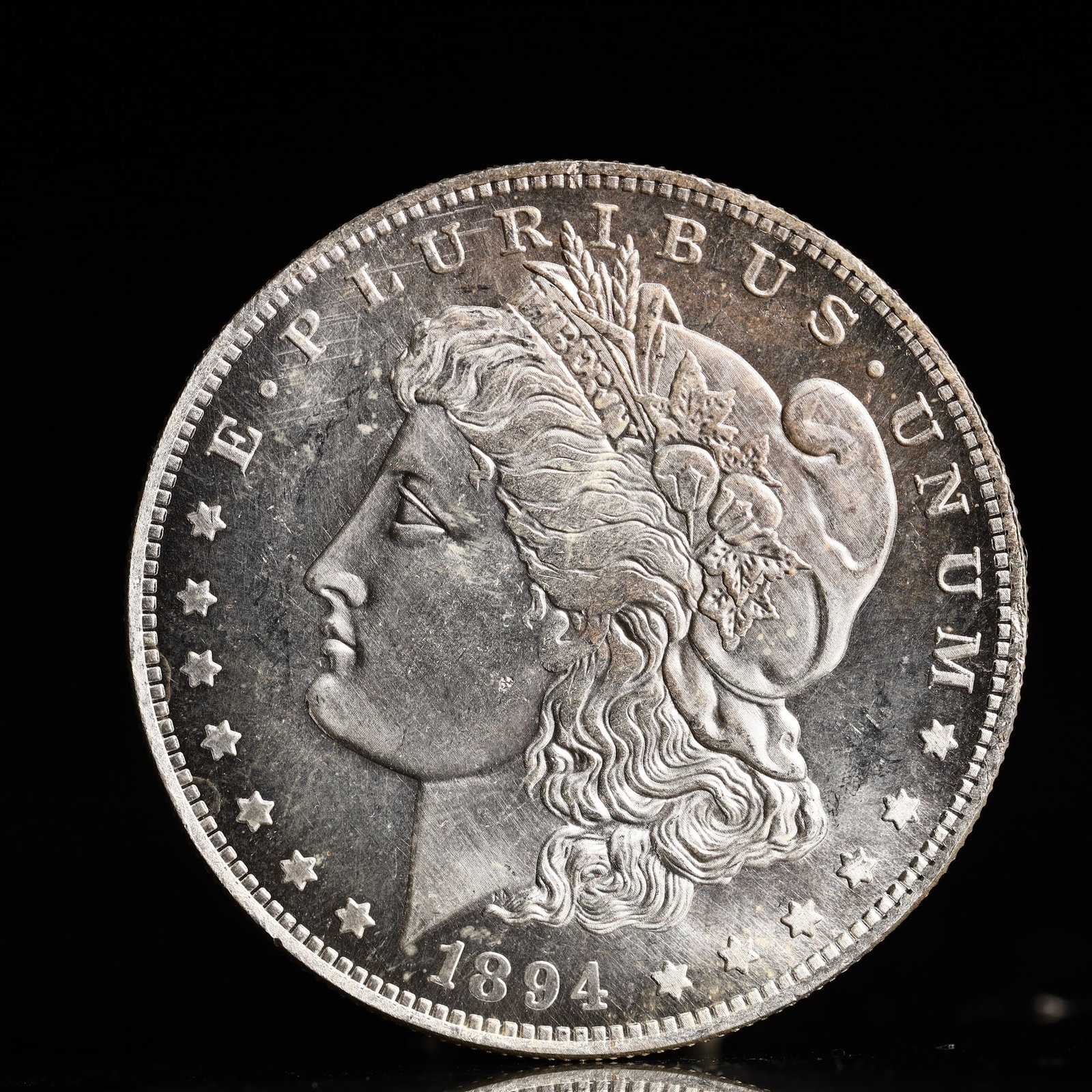 USA Morgan Dollar 1894 Coin: Obv: profile bust with date below and E PLURIBUS UNUM legend and stars around. Rev: eagle with In God we trust above within wreath with UNITED STATES OF AMERICA ONE DOLLAR legend. IN GOD WE TRUST / LI