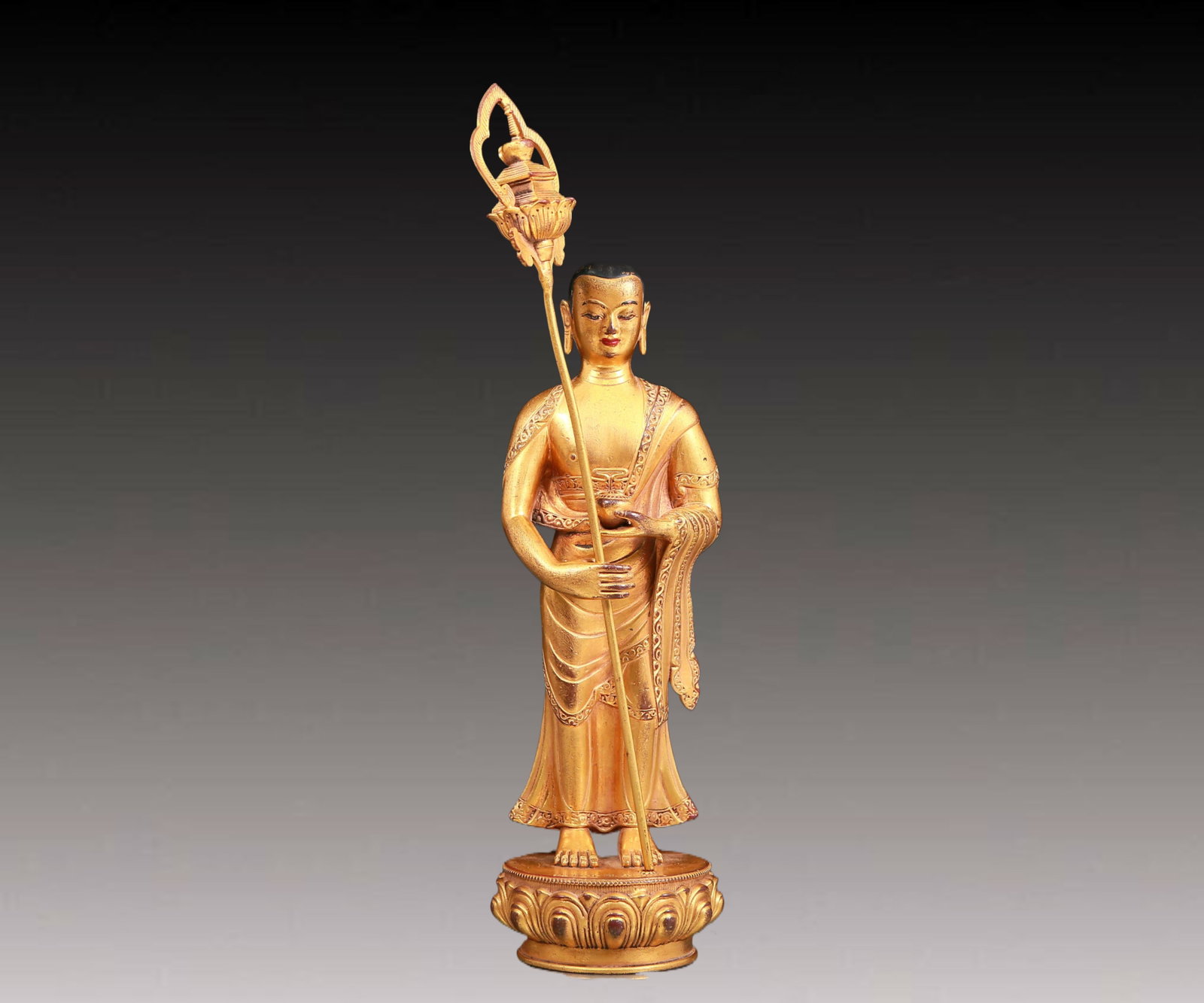 A solemn gilt bronze Arhat statue: A solemn gilt bronze Arhat statue,Kangxi seven-character mark,Qing Dynasty,China. The details of the Arhat are carved lifelike,including clothing patterns,facial features,etc. Every detail shows the s