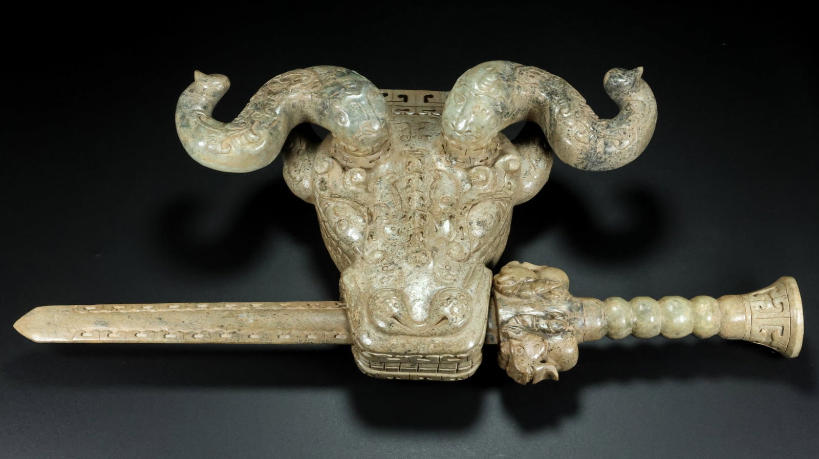 An Exquisite White Jade Buffalo Head Sword Ornament: An Exquisite White Jade Buffalo Head Sword Ornament,Han Dynasty,China,Size:(Buffalo 头)14.2inx9.8inx4.3in,(Sword)22.2inx4.5inx2.3in,Weight:5400g,白玉牛头宝剑&