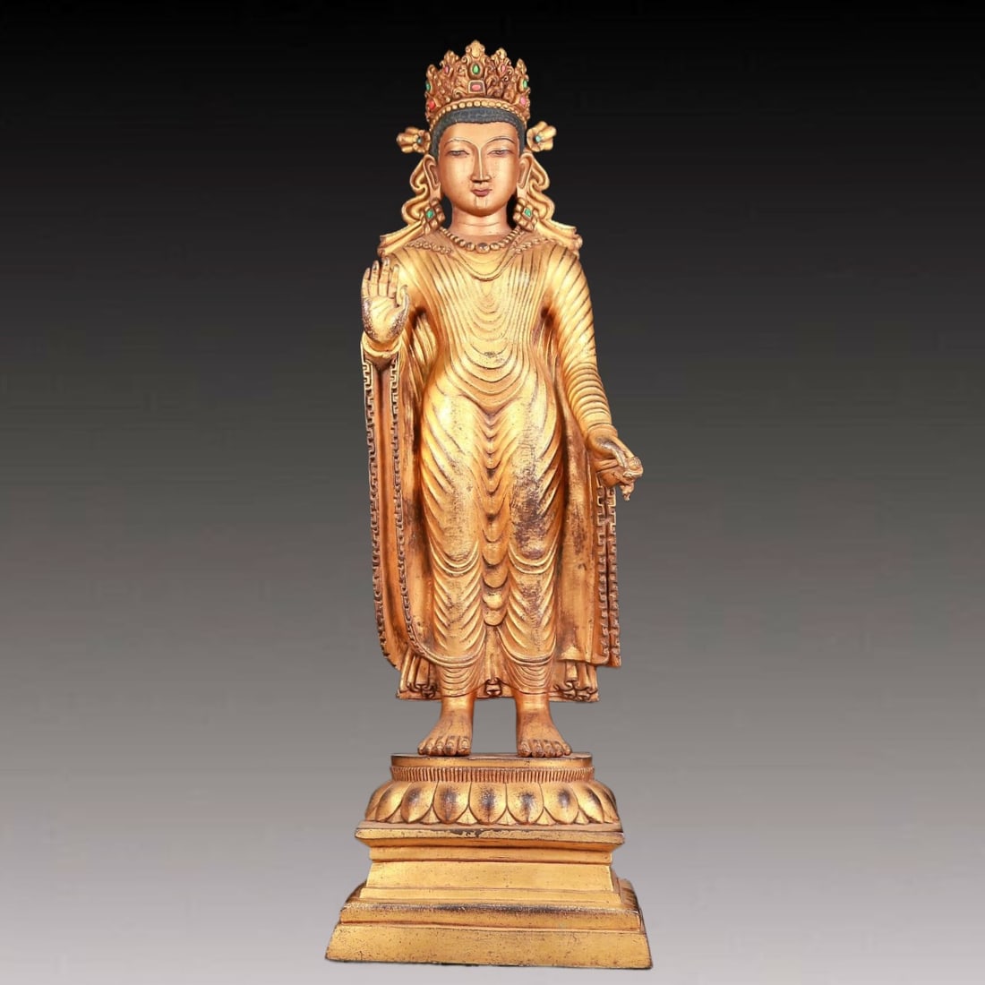 A solemn gilt bronze statue of Tathagata inlaid gems: A solemn gilt bronze statue of Tathagata inlaid gems,with inscription,Qianlong mark,Qing Dynasty,China,Size:8.7inx5.5inx26.4in,Weight:17.380kg