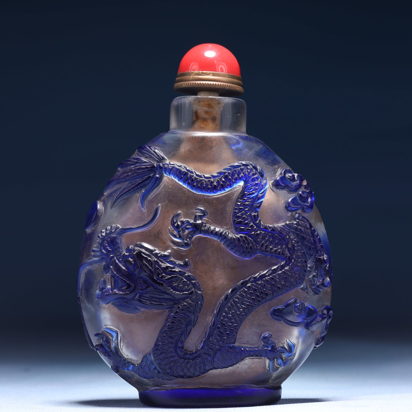 An Exquisite Glass Auspicious Cloud and Dragon Pattern Snuff Bottle: An Exquisite Glass Auspicious Cloud and Dragon Pattern Snuff Bottle,Qing Dynasty,China,Size:3.1inx1.2inx4.3in,Weight:257g