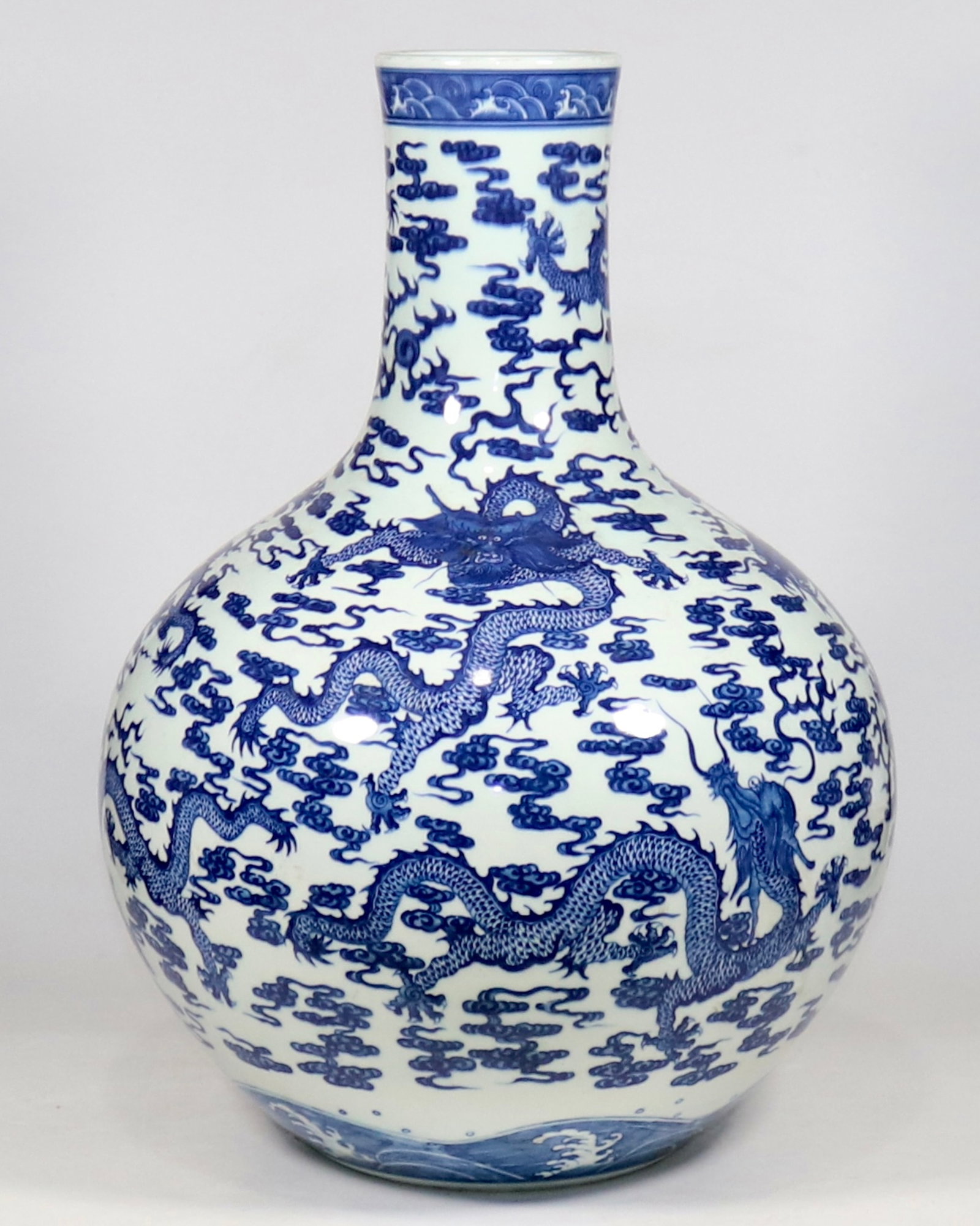 A fine large blue and white nine-dragon celestial globe vase: A fine large blue and white nine-dragon celestial globe vase, Qing Dynasty, China, with six-character Qianlong reign mark, Size:21.7inA fine large blue and white nine-dragon celestial globe vase, Qing