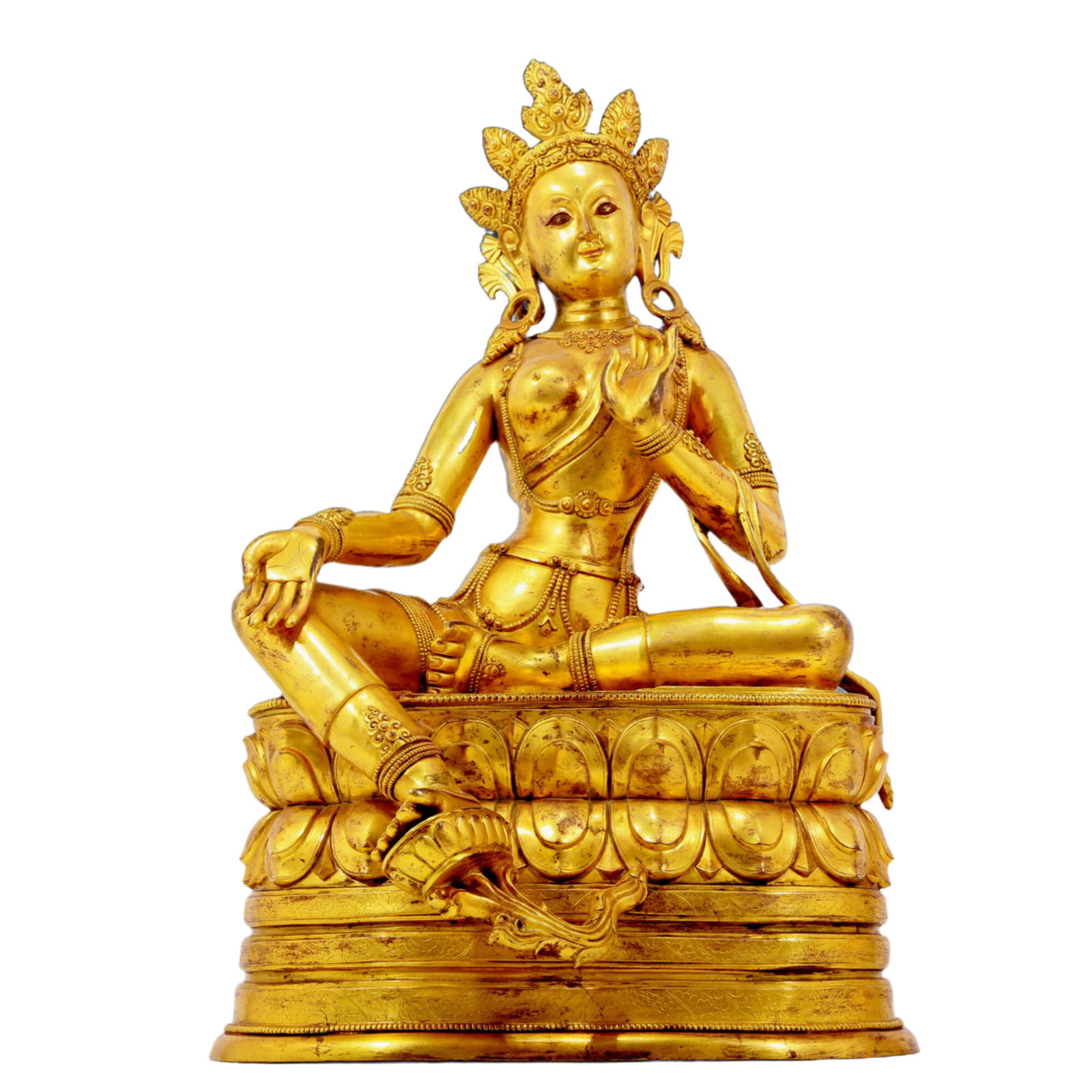 A solemn gilt bronze statue of green Tara: A solemn gilt-bronze green Tara statue, Qianlong seven-character inscription, Qing Dynasty, China. Tara has an elegant posture with a peaceful and compassionate expression. Her face is soft and solemn