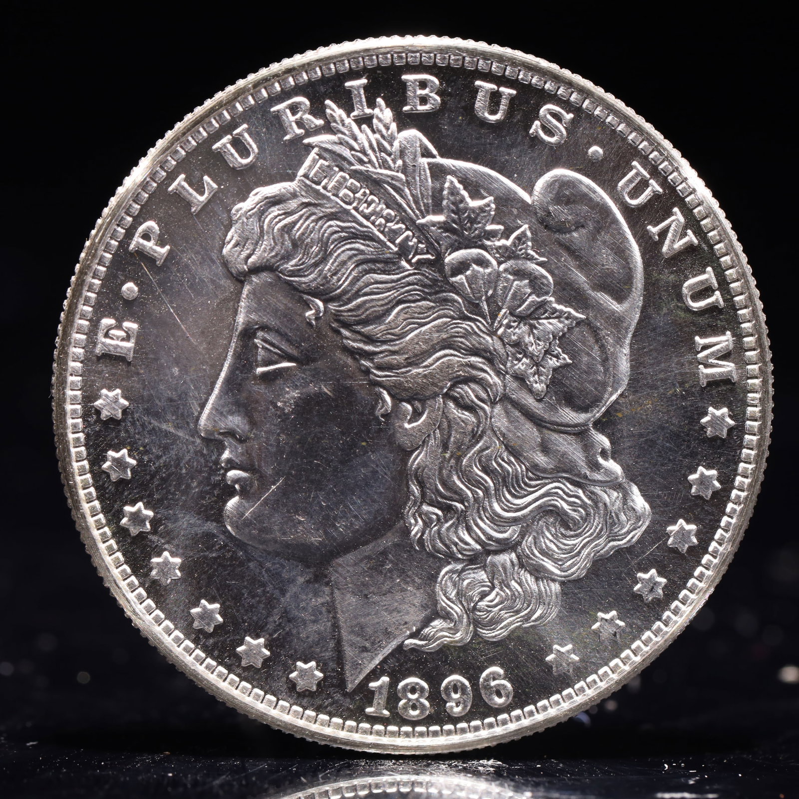 USA Morgan Dollar 1896 Coin: Obv: profile bust with date below and E PLURIBUS UNUM legend and stars around. Rev: eagle with In God we trust above within wreath with UNITED STATES OF AMERICA ONE DOLLAR legend. IN GOD WE TRUST / LI