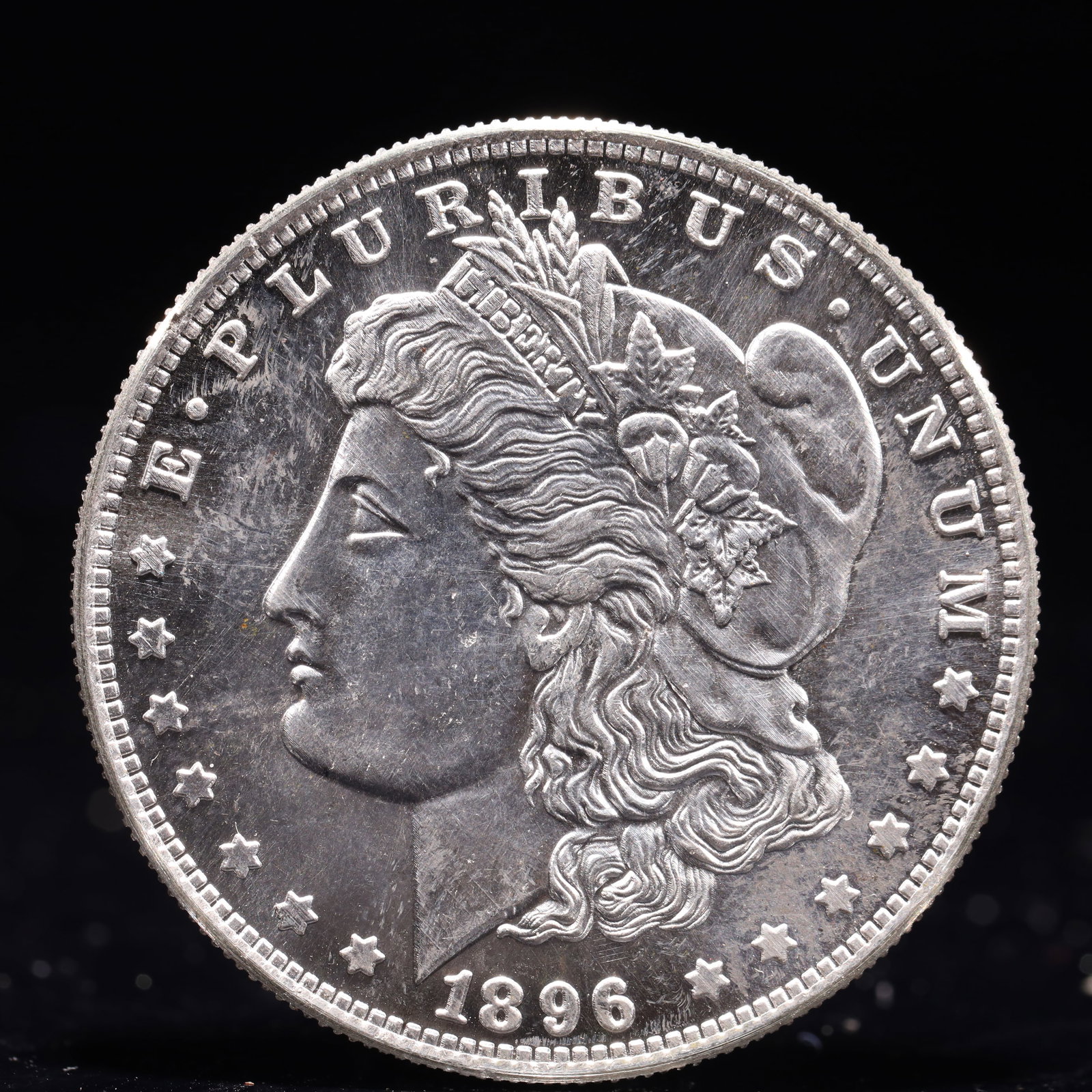 USA Morgan Dollar 1896 Coin: Obv: profile bust with date below and E PLURIBUS UNUM legend and stars around. Rev: eagle with In God we trust above within wreath with UNITED STATES OF AMERICA ONE DOLLAR legend. IN GOD WE TRUST / LI