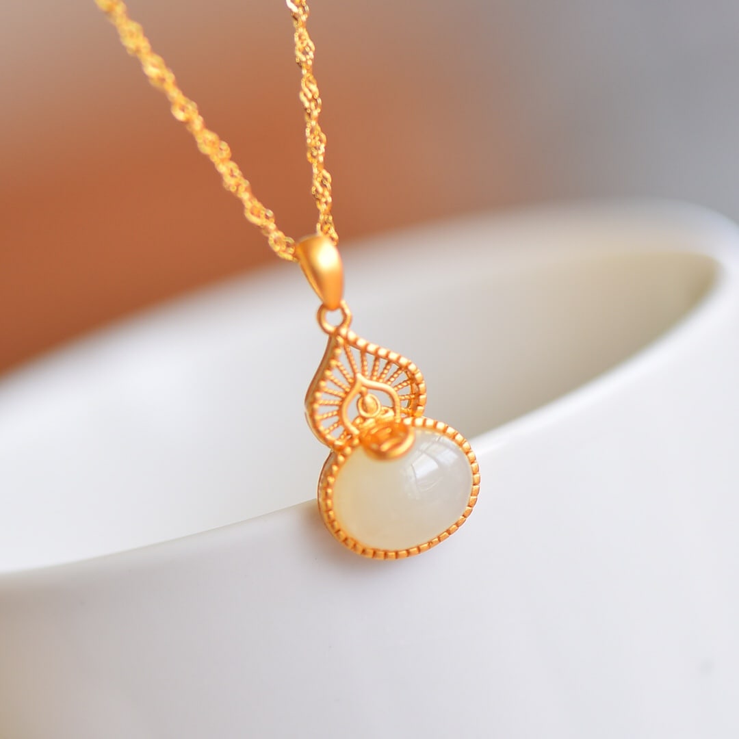 A Pair of Exquisite Sterling Silver-Gold Plated Inlaid White Jade Jewely: A Pair of Exquisite Sterling Silver-Gold Plated Inlaid White Jade Jewelry,Size:(Necklace)9mmx11mm,(Earrings)6mmx8mm 一套纯银镀金镶白玉首'