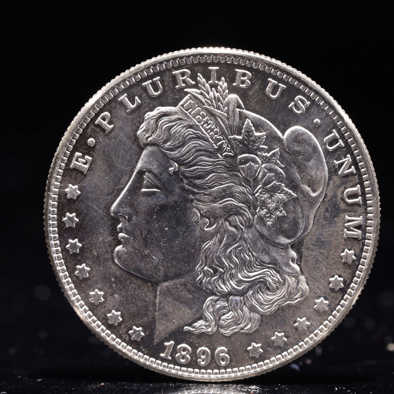USA Morgan Dollar 1896 Coin: Obv: profile bust with date below and E PLURIBUS UNUM legend and stars around. Rev: eagle with In God we trust above within wreath with UNITED STATES OF AMERICA ONE DOLLAR legend. IN GOD WE TRUST /