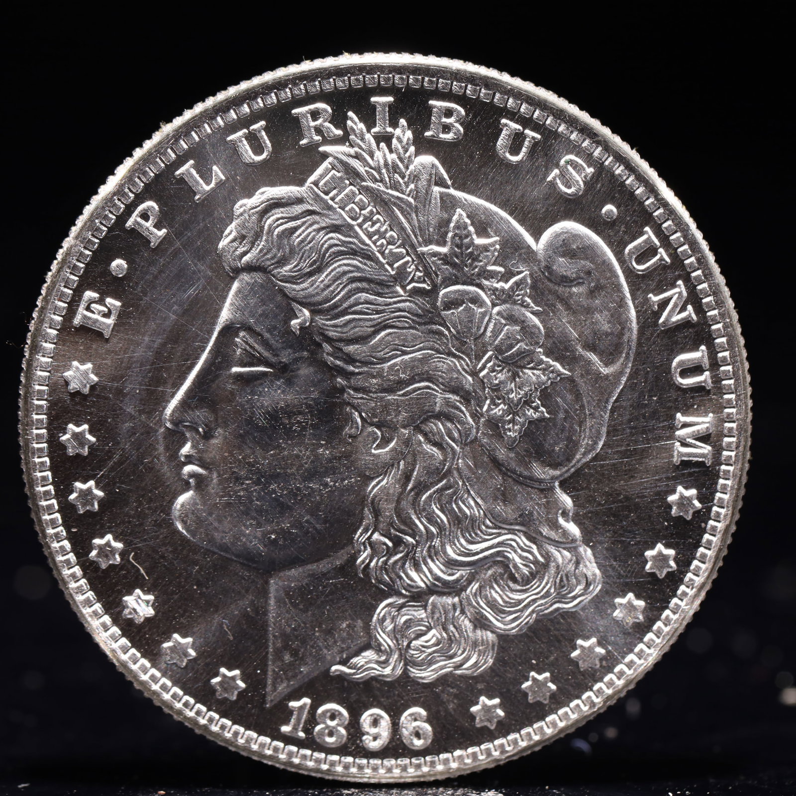 USA Morgan Dollar 1896 Coin: Obv: profile bust with date below and E PLURIBUS UNUM legend and stars around. Rev: eagle with In God we trust above within wreath with UNITED STATES OF AMERICA ONE DOLLAR legend. IN GOD WE TRUST / LI