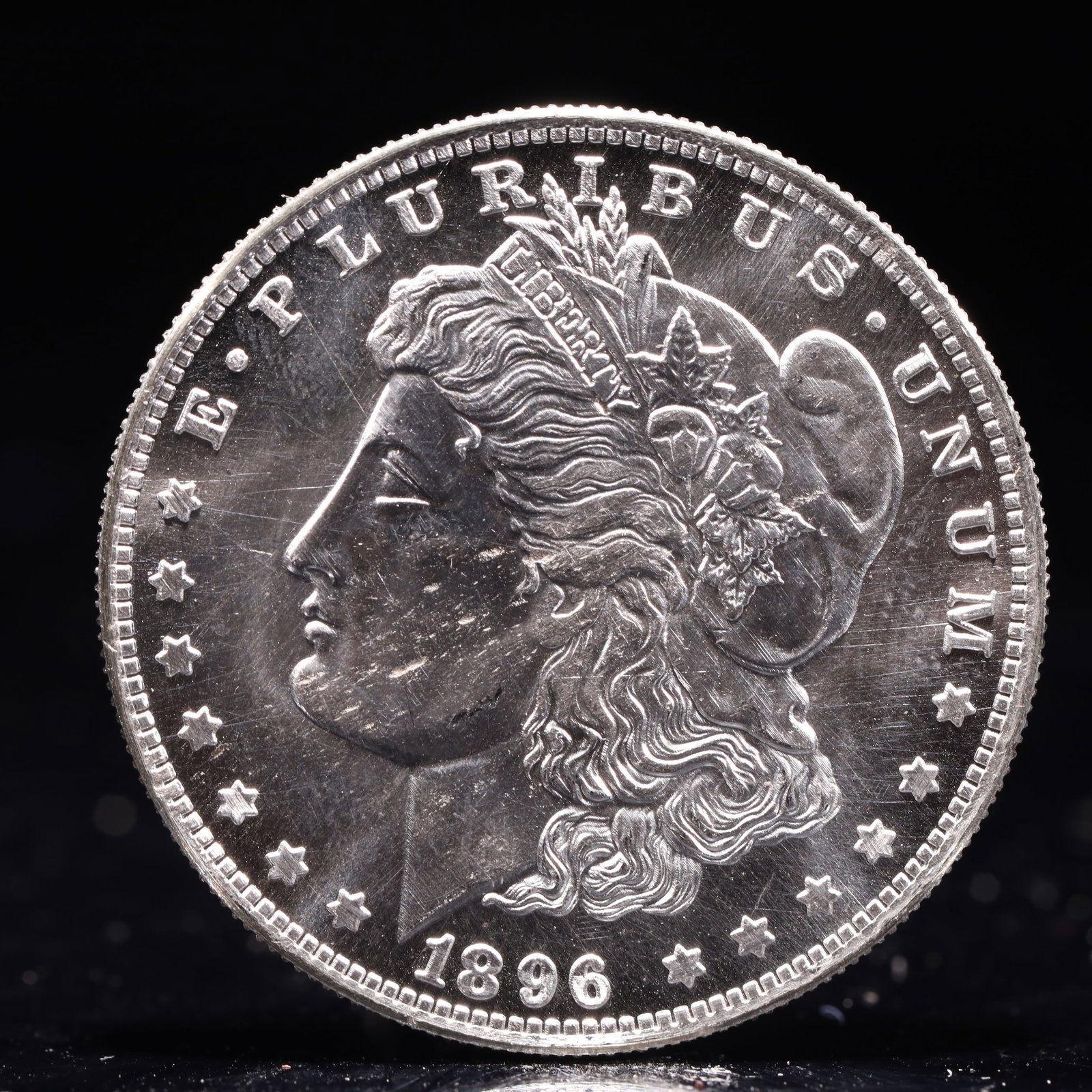 USA Morgan Dollar 1896 Coin: Obv: profile bust with date below and E PLURIBUS UNUM legend and stars around. Rev: eagle with In God we trust above within wreath with UNITED STATES OF AMERICA ONE DOLLAR legend. IN GOD WE TRUST / LI