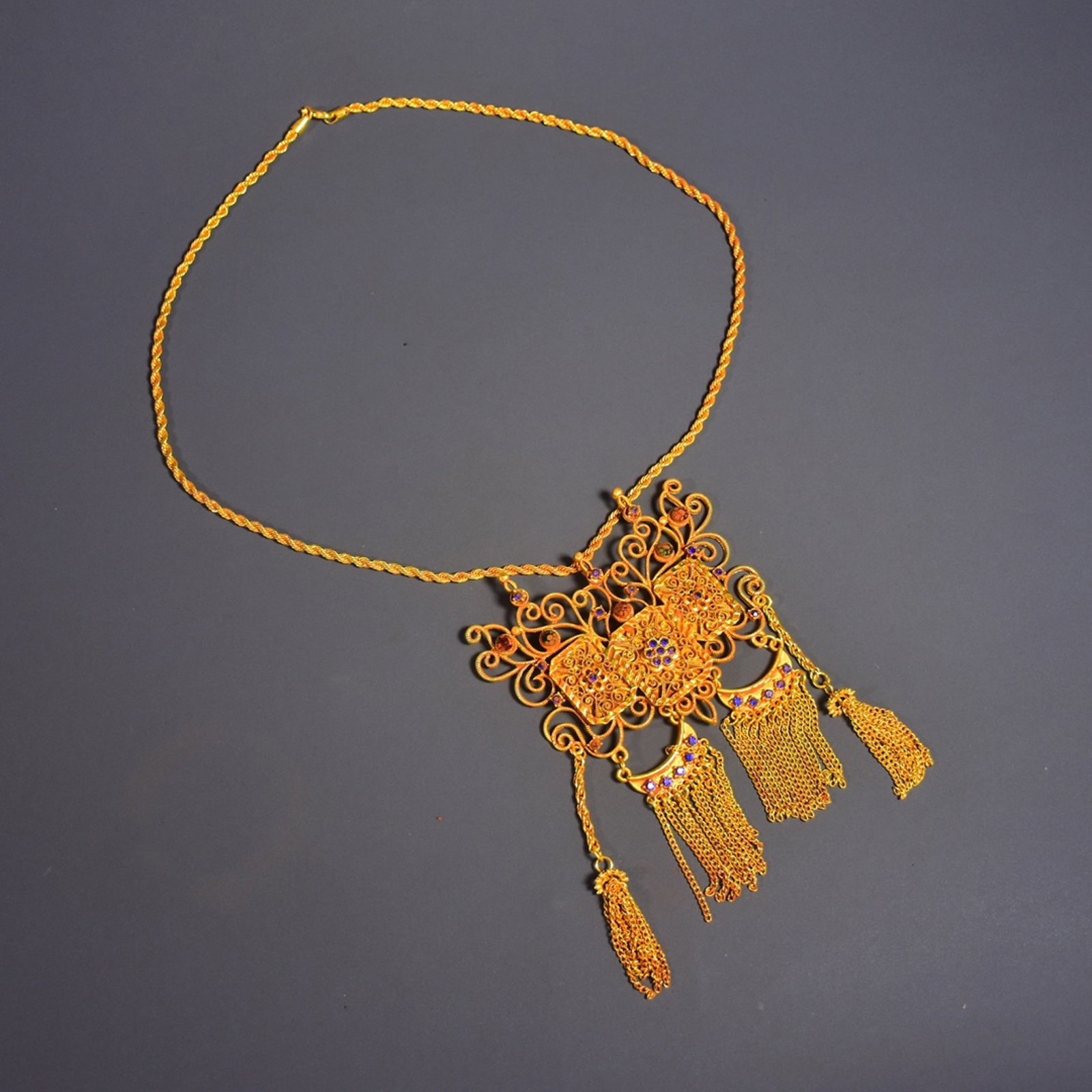 A Huge Gilt Bronze Flower Pattern Pendant,Inlaid Gems: A Huge Gilt Bronze Flower Pattern Pendant,Inlaid Gems,Qing Dynasty,China,Size:19.7inx4.3in,Weight:114g 铜鎏金花卉纹吊坠,嵌宝石,中