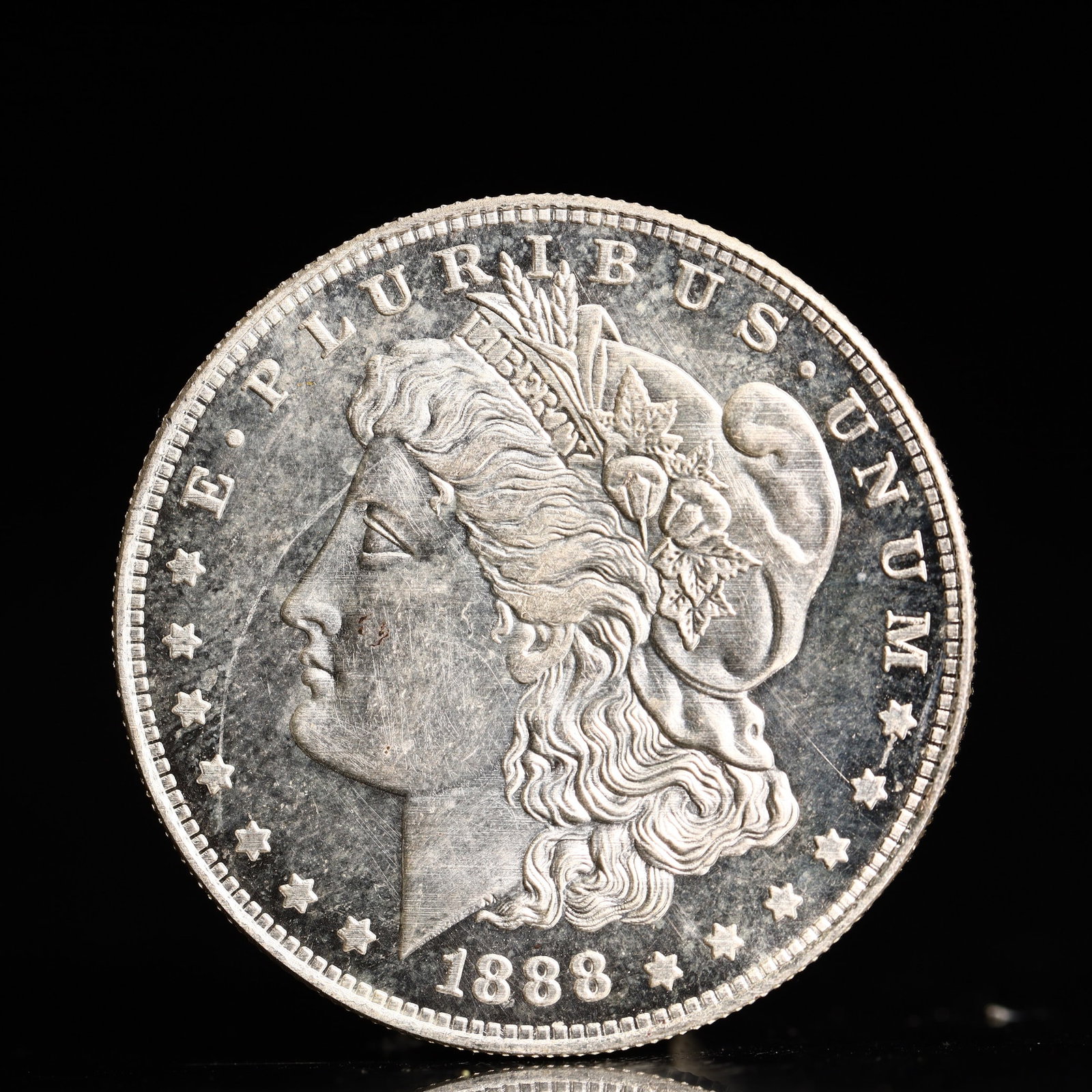 USA Morgan Dollar 1888 Coin: Obv: profile bust with date below and E PLURIBUS UNUM legend and stars around. Rev: eagle with In God we trust above within wreath with UNITED STATES OF AMERICA ONE DOLLAR legend. IN GOD WE TRUST /