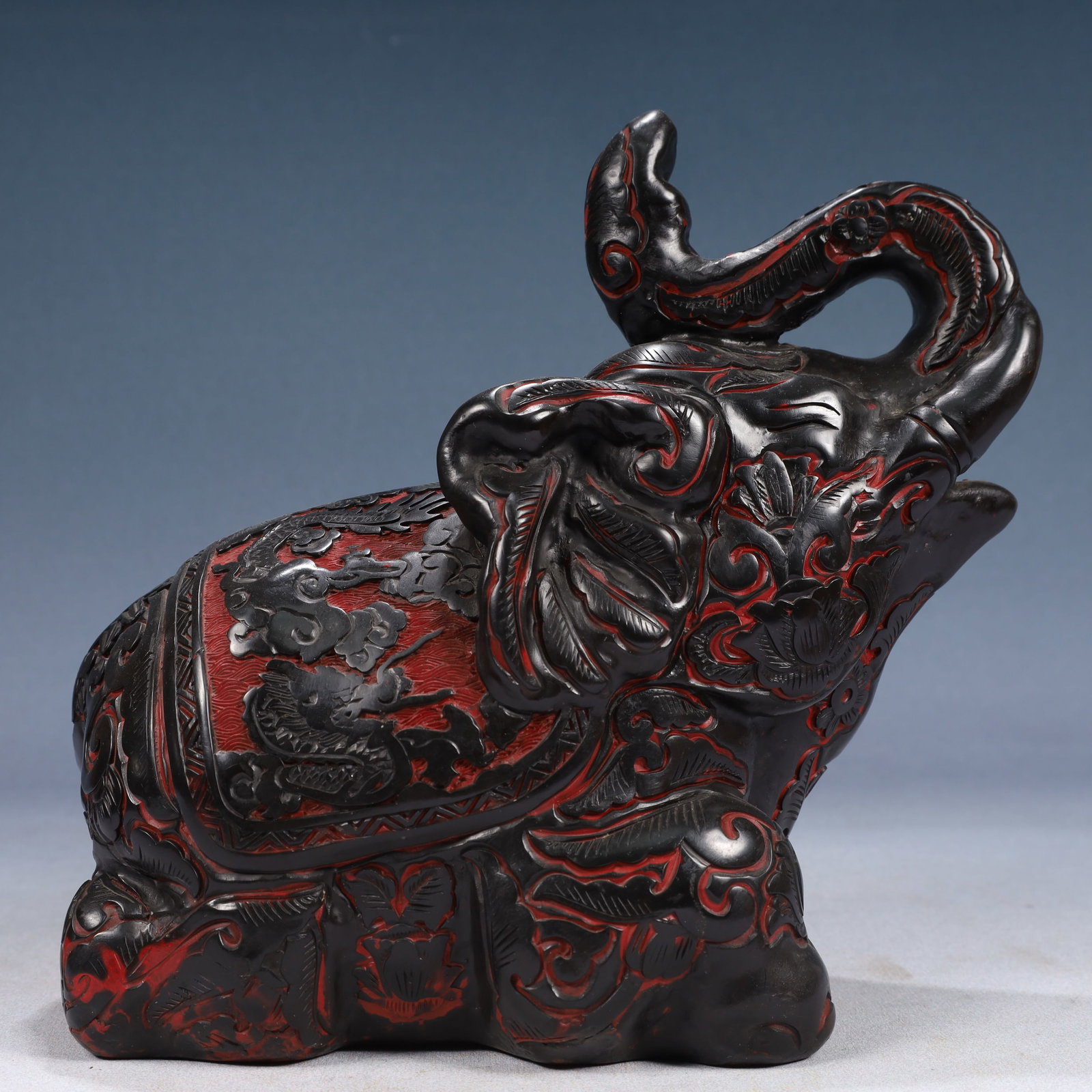 An Exquisite Black Lacquer Auspicious Cloud and Dragon Pattern Elephant Ornament: An Exquisite Black Lacquer Auspicious Cloud and Dragon Pattern Elephant Ornament,Qing Dynasty, China,Size:9.8inx4.7inx8.7in,Weight:2050g 黑漆祥云龙纹大象